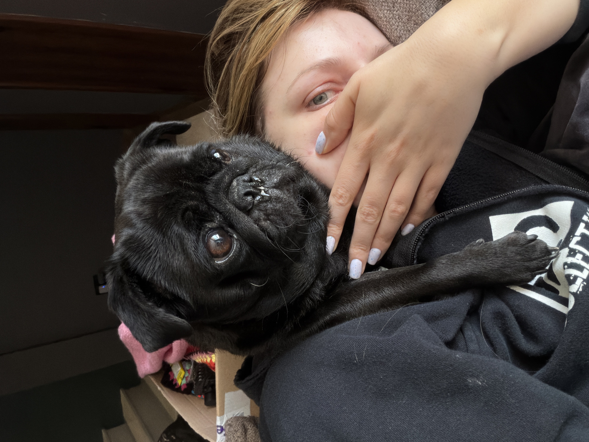 Woman poses with black pug in Razlog, Bulgaria