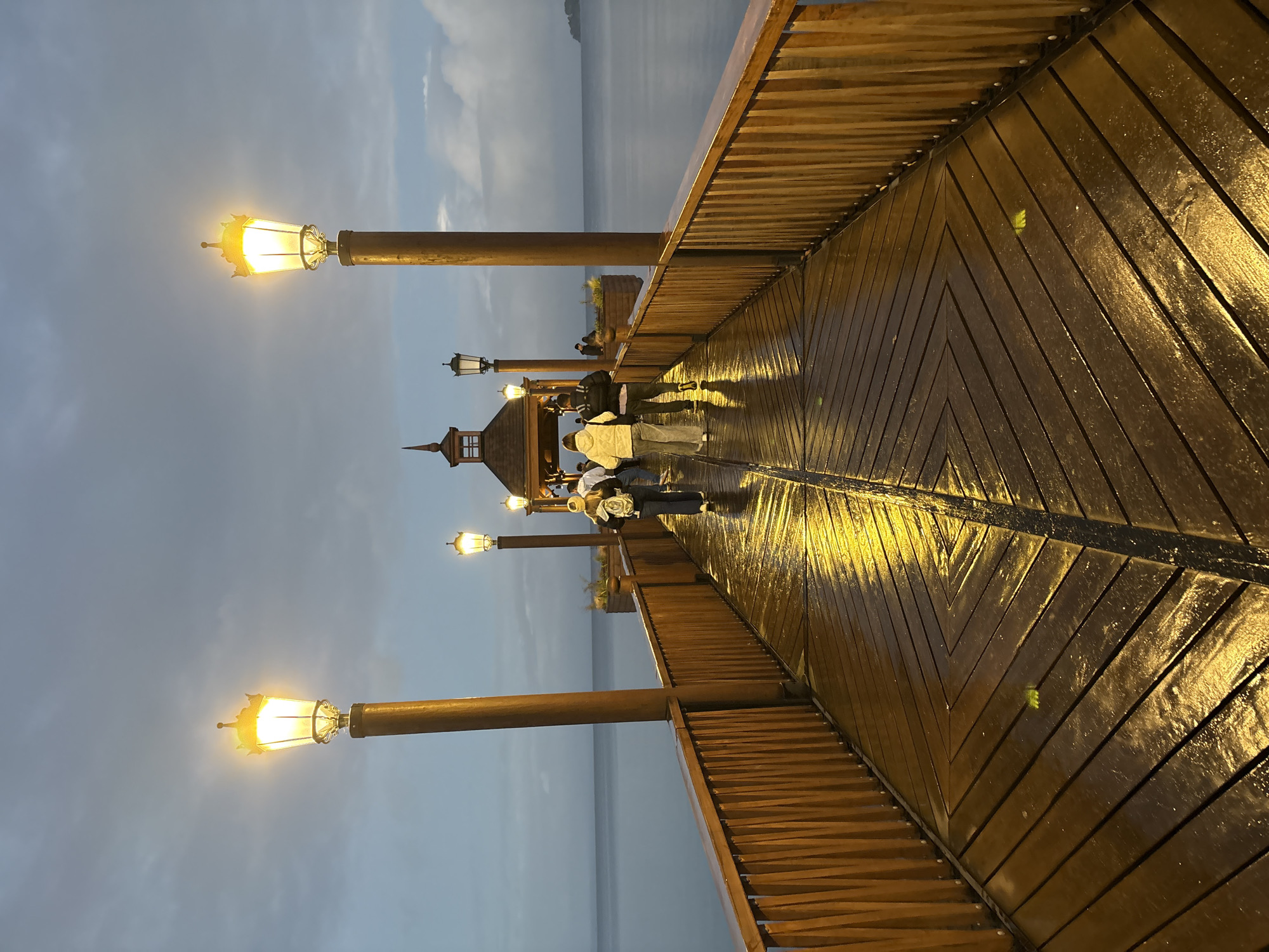 Evening stroll captured on illuminated pier in Frutillar, Chile