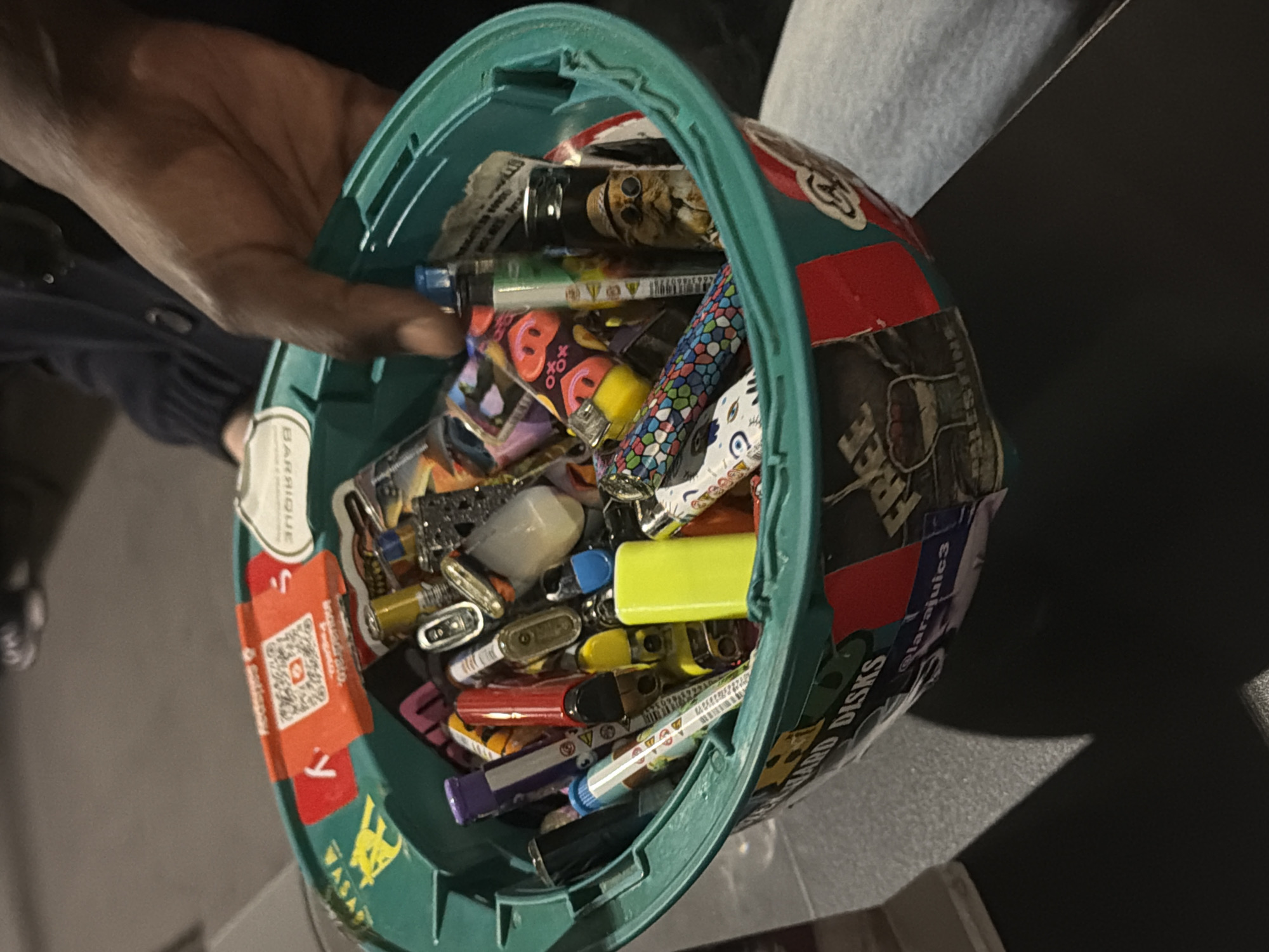 Person holds container filled with lighters in Milan