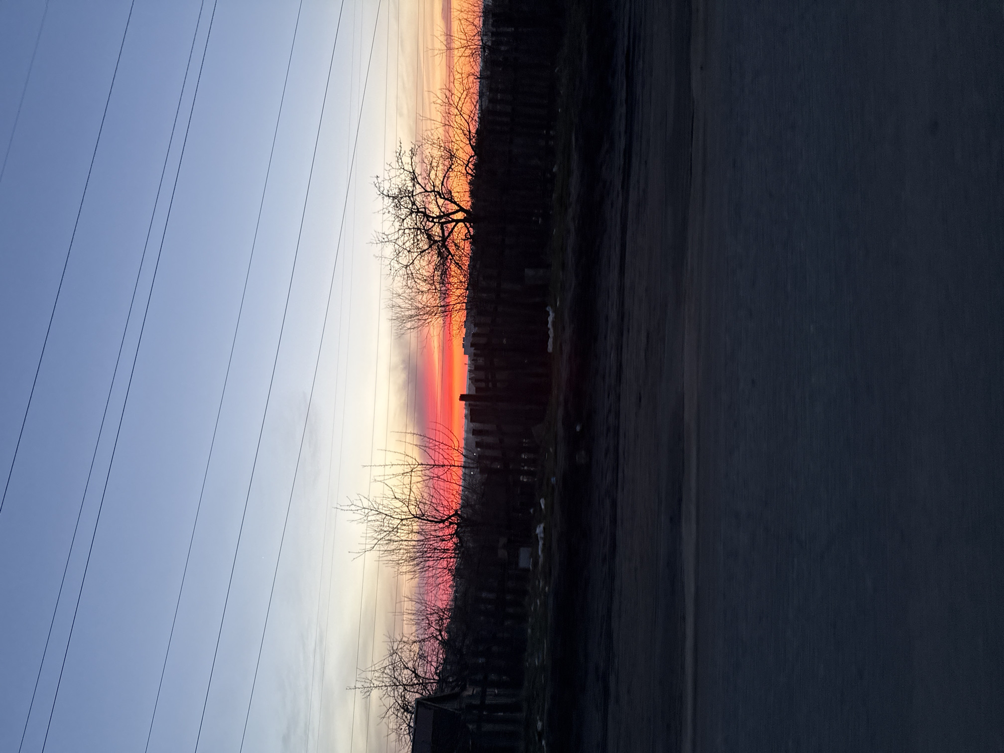 Sunset observed in Chaikovsky, Russia displays orange-blue sky gradients