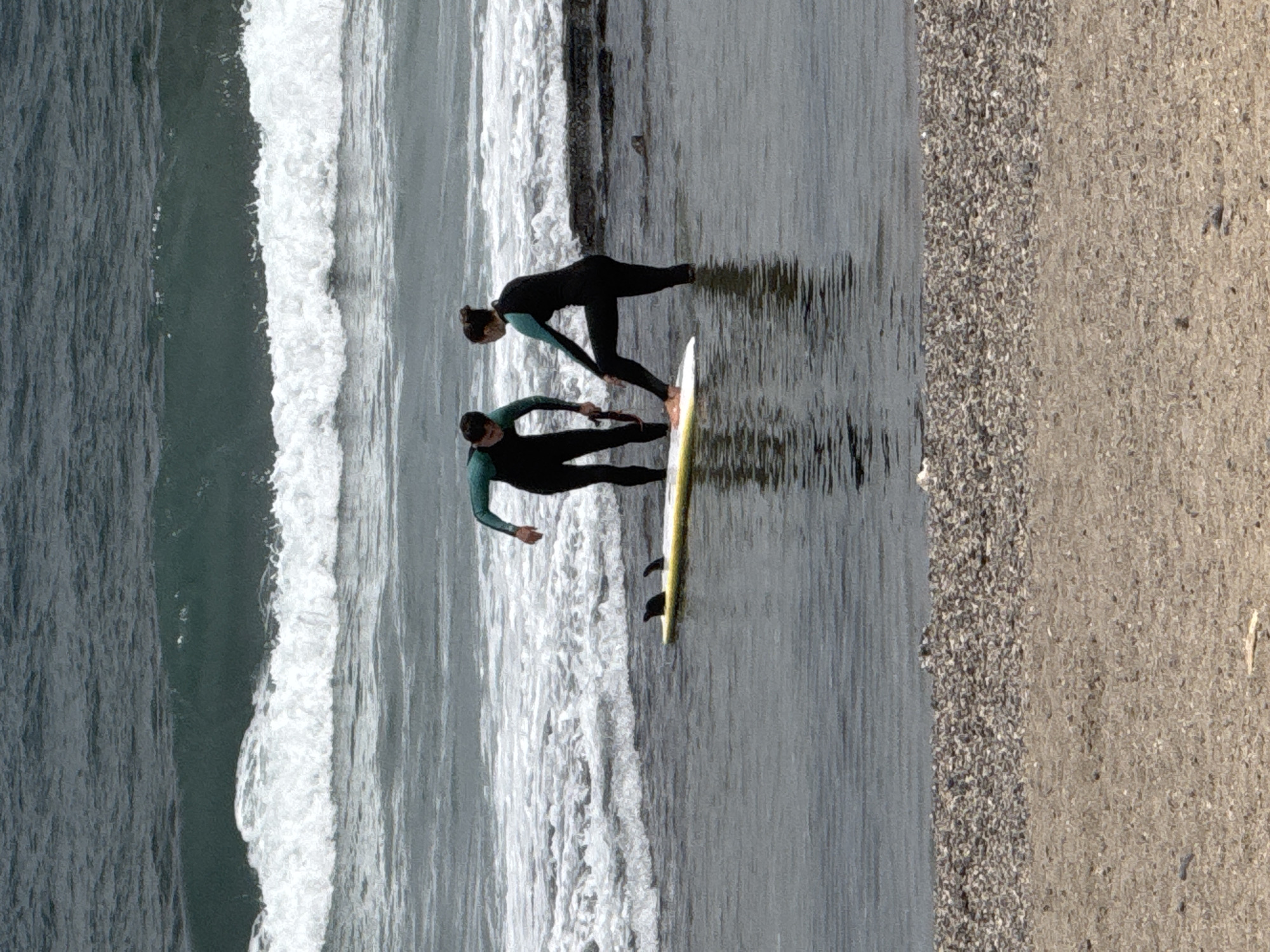 Arona beach day: surfers, lifeguard tower, and promenade life