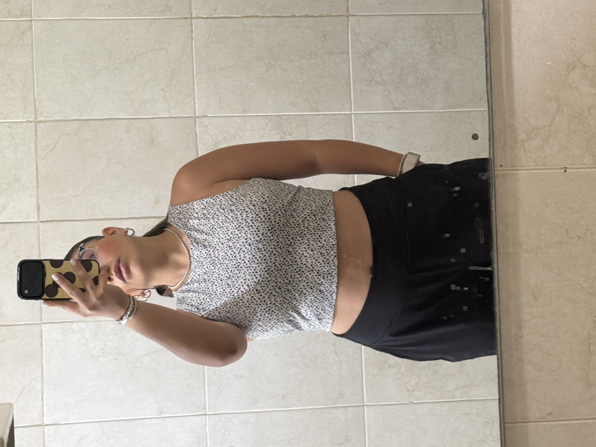 Young person takes mirror selfie in Puebla bathroom