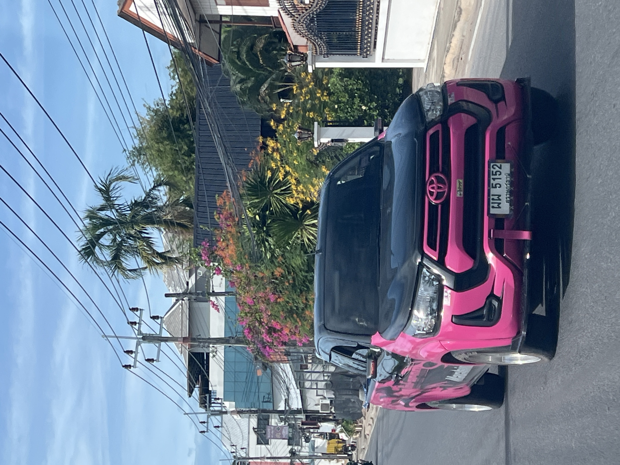 Pink-accented Hilux Revo cruising Ko Samui's wire-lined streets