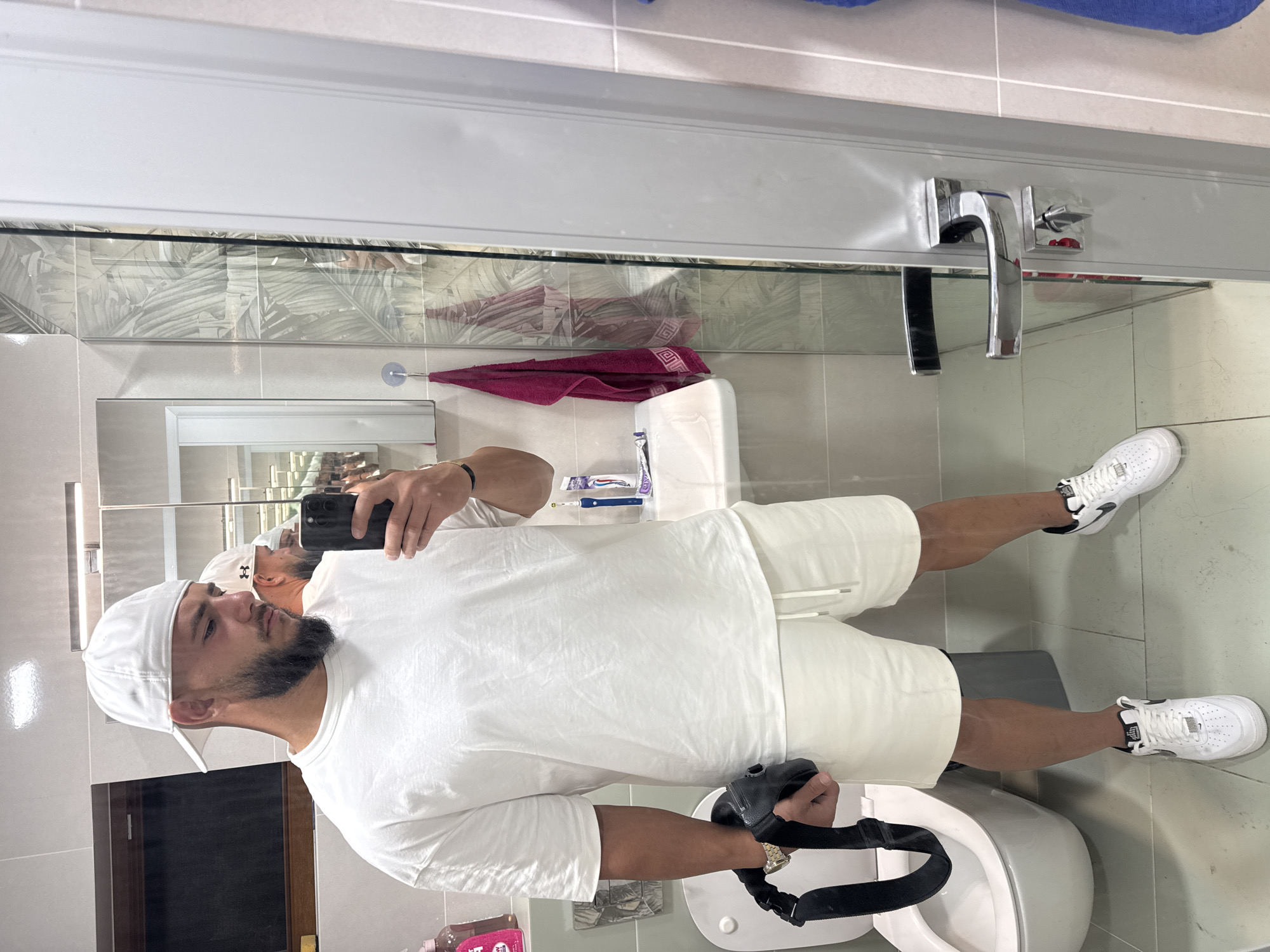 Mirror selfie session in a Sofia bathroom, all-white fit