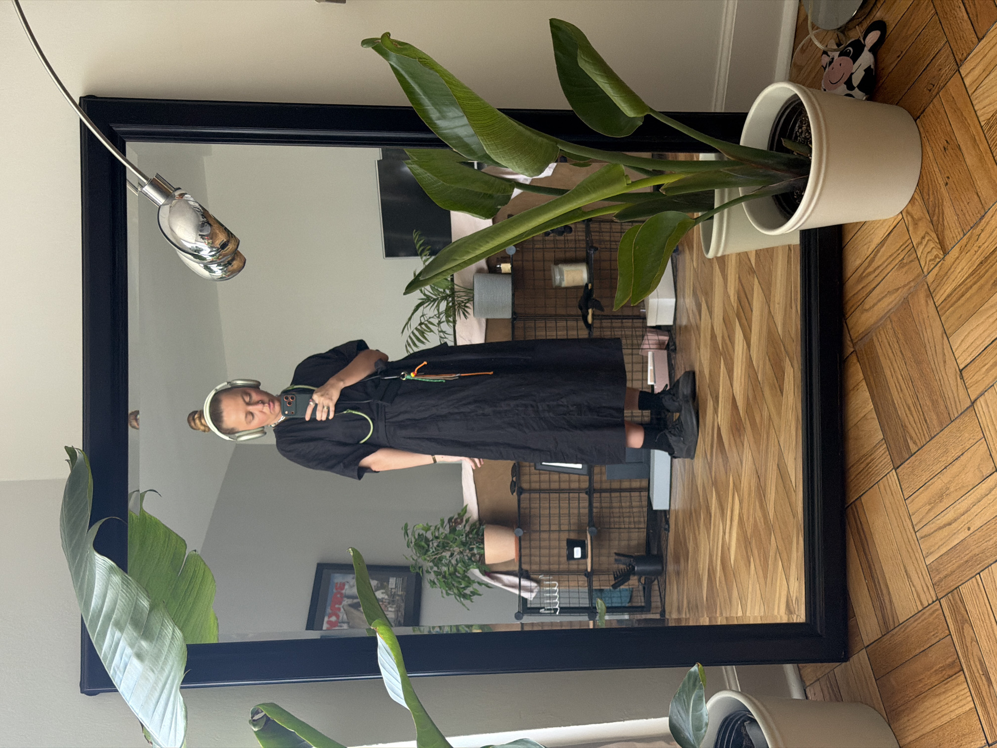 Person takes mirror selfie in black dress, Los Angeles