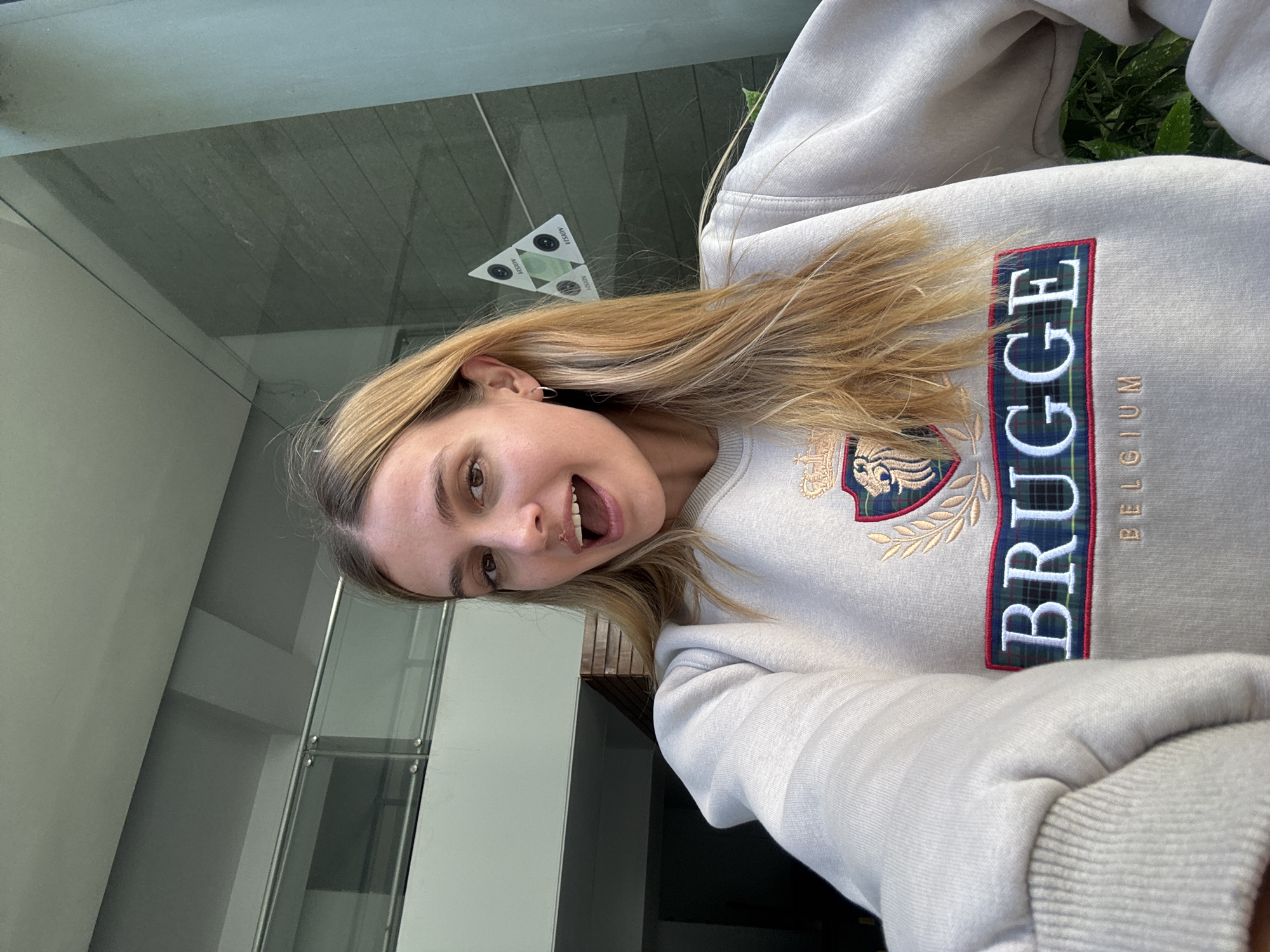 Woman takes selfies, uses tablet in Tbilisi indoor location