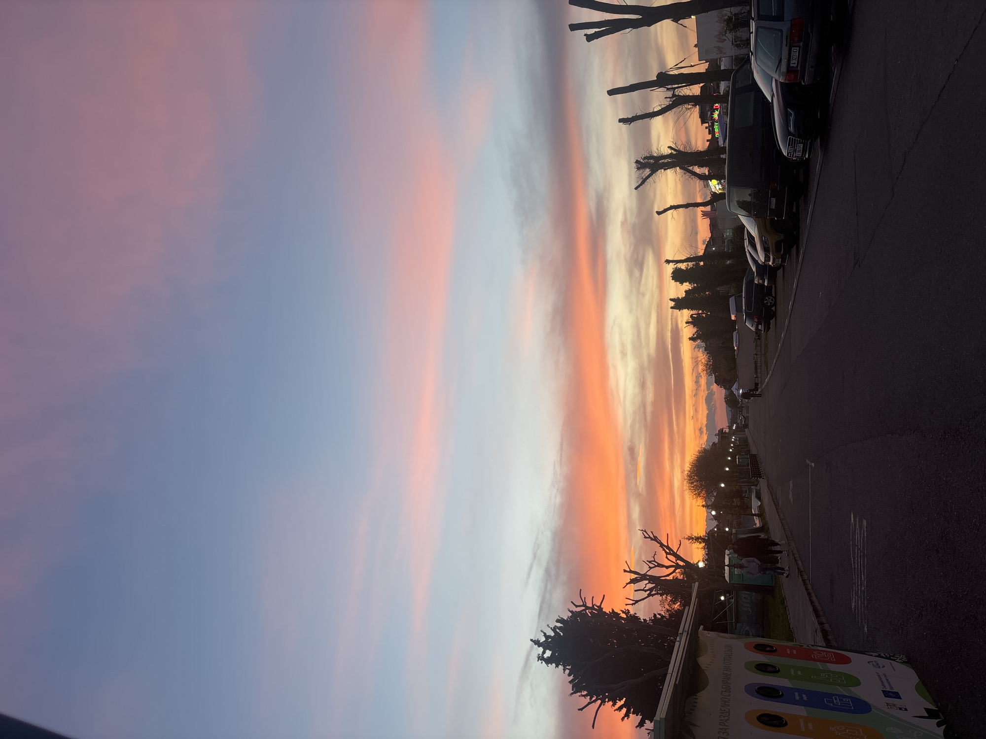 Vibrant sunset colors illuminate street scene in Pomorie, Bulgaria