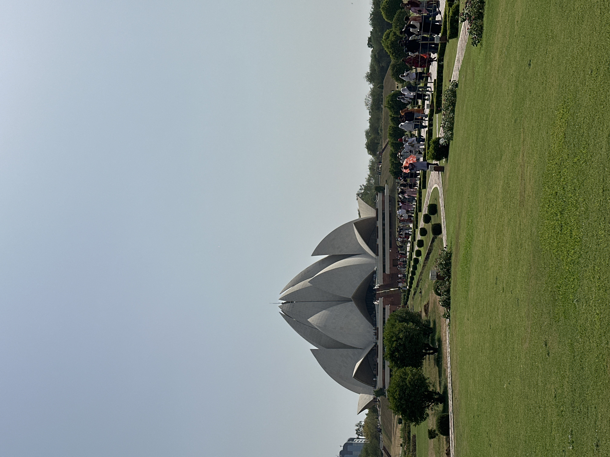 Visitors gather at Delhi's iconic Lotus Temple under clear skies