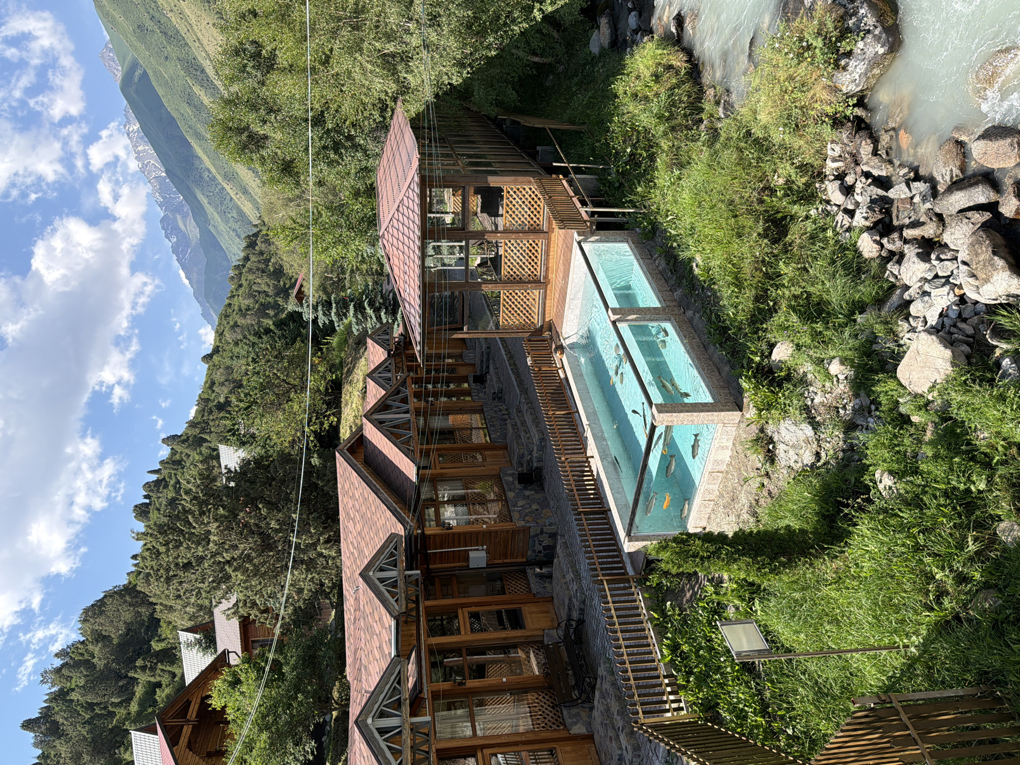Mountain resort stop with river views and rustic architecture