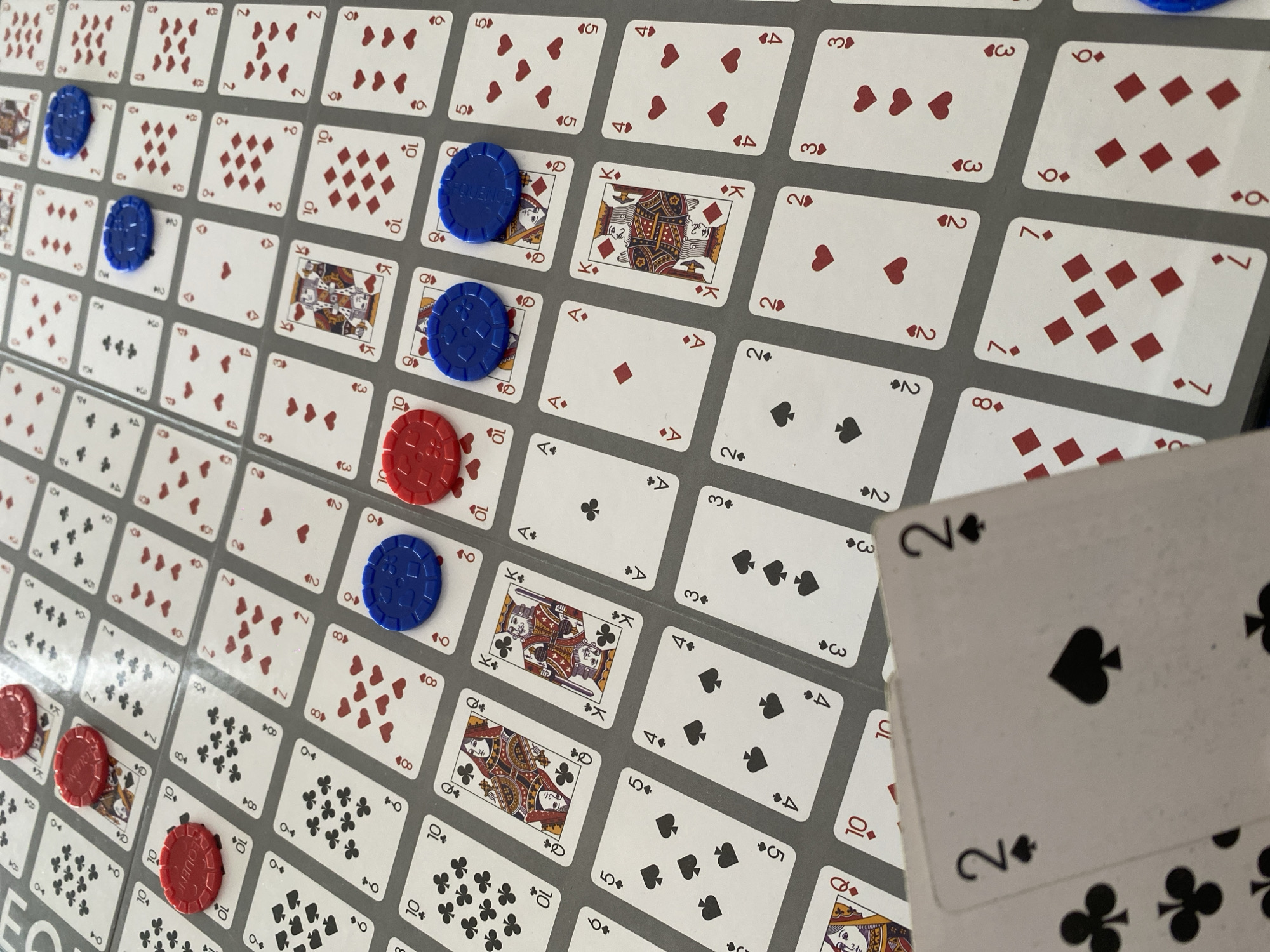 Board game session captured with Sequence game in progress