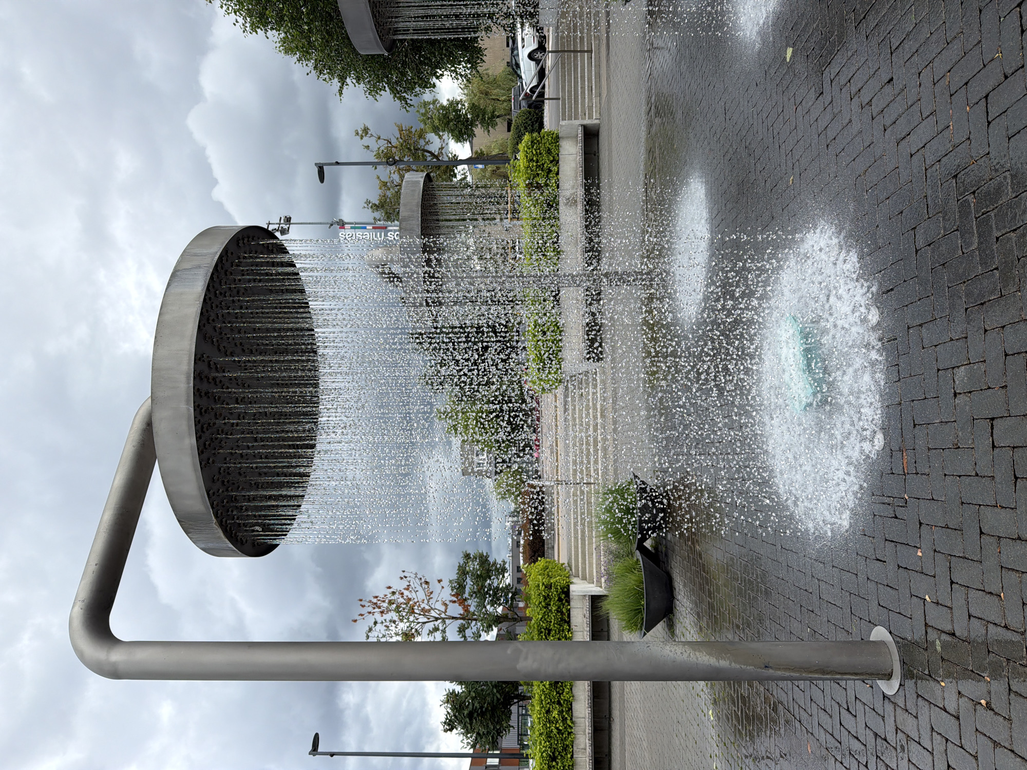 Vilnius plaza fountain installation rains water from oversized shower heads