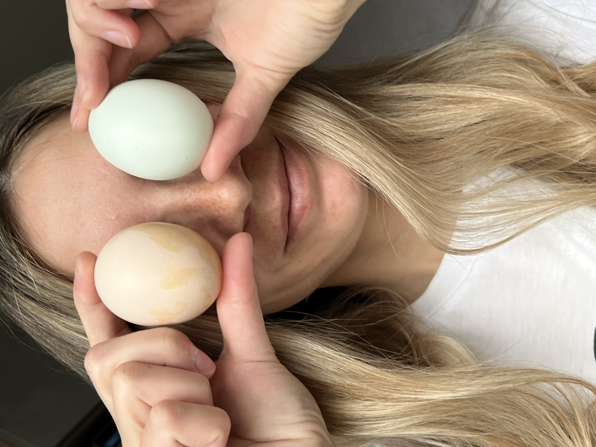 Person poses playfully with eggs over eyes in Chaikovsky