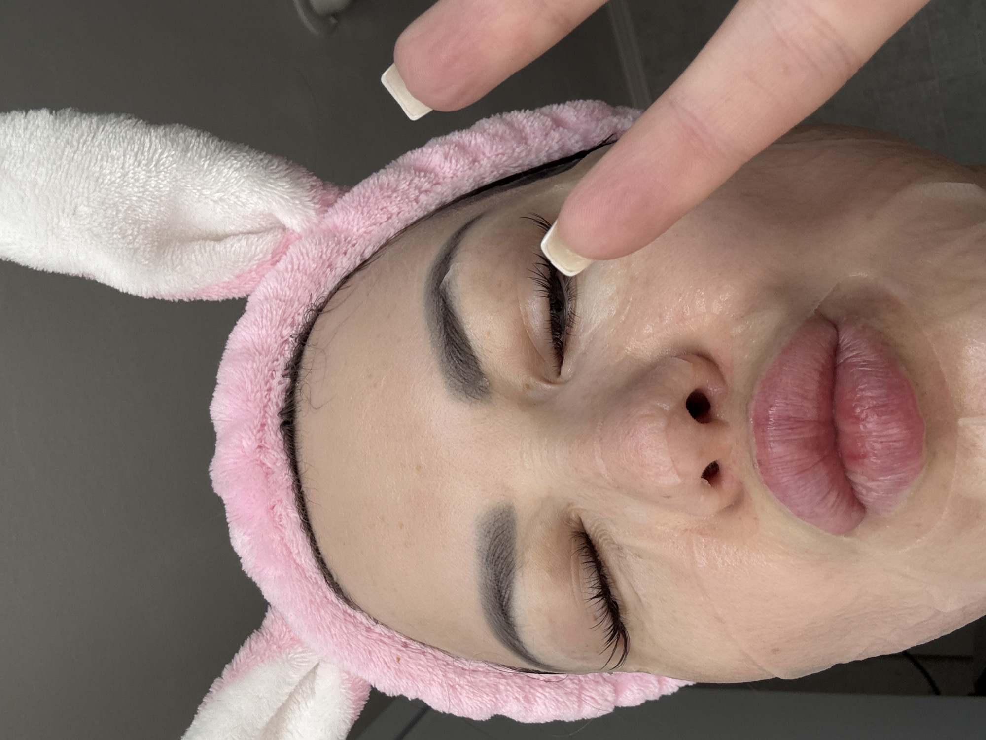 Person rests wearing bunny headband during indoor treatment session