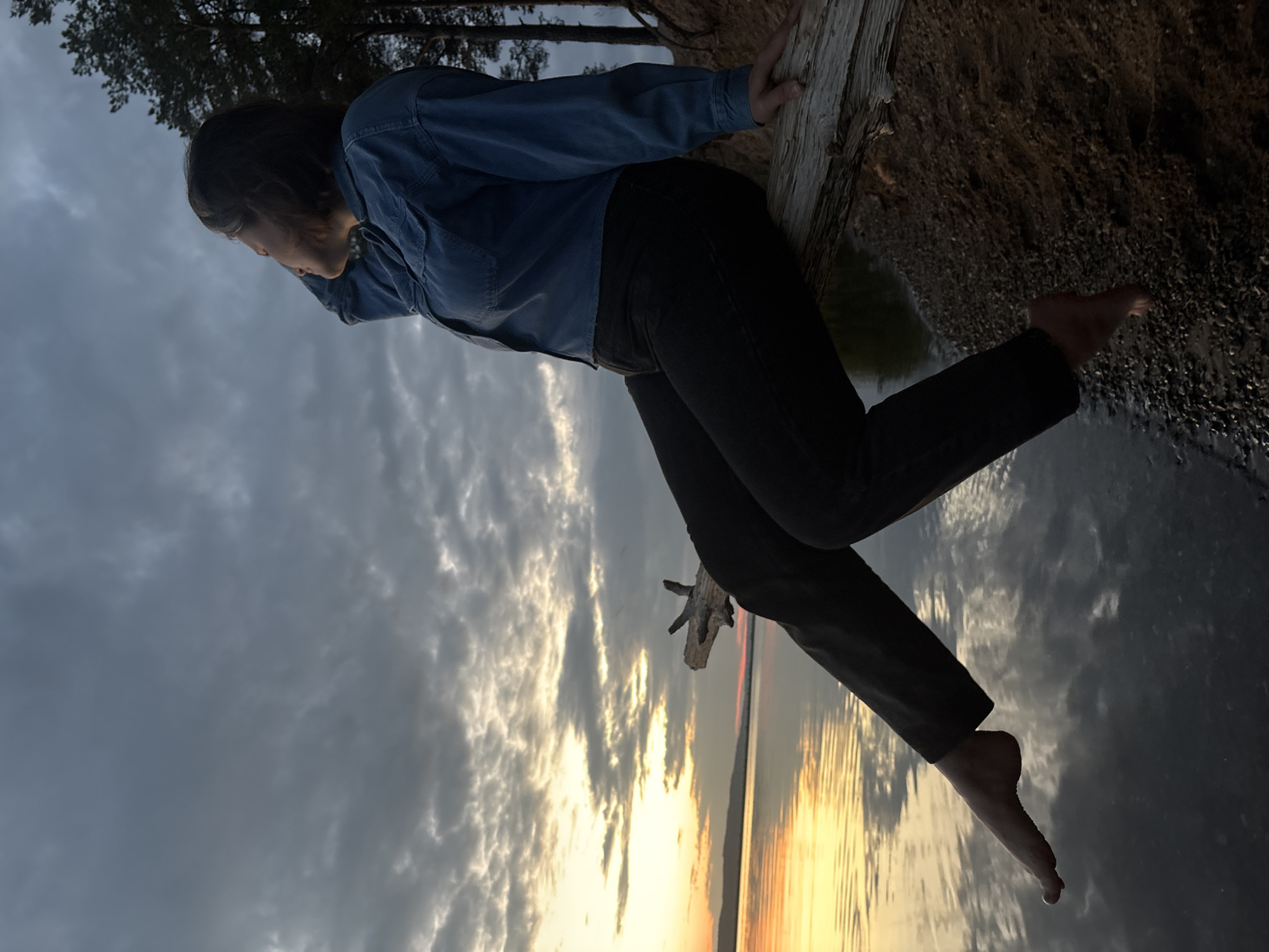 Mother and daughter enjoy sunset waterfront outing with nearby performances