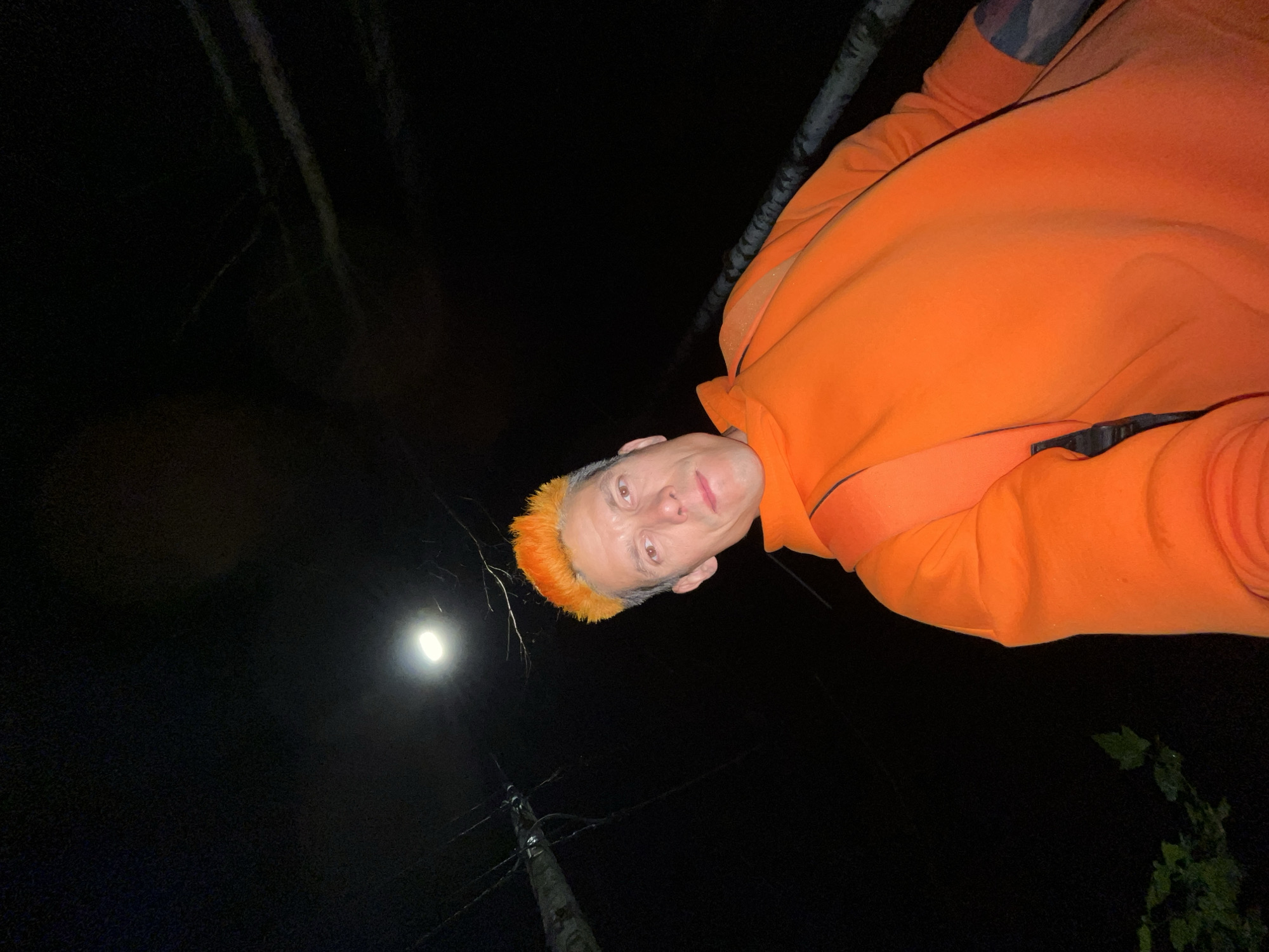 Orange-haired individual documents nighttime walk through Chaikovsky, Russia