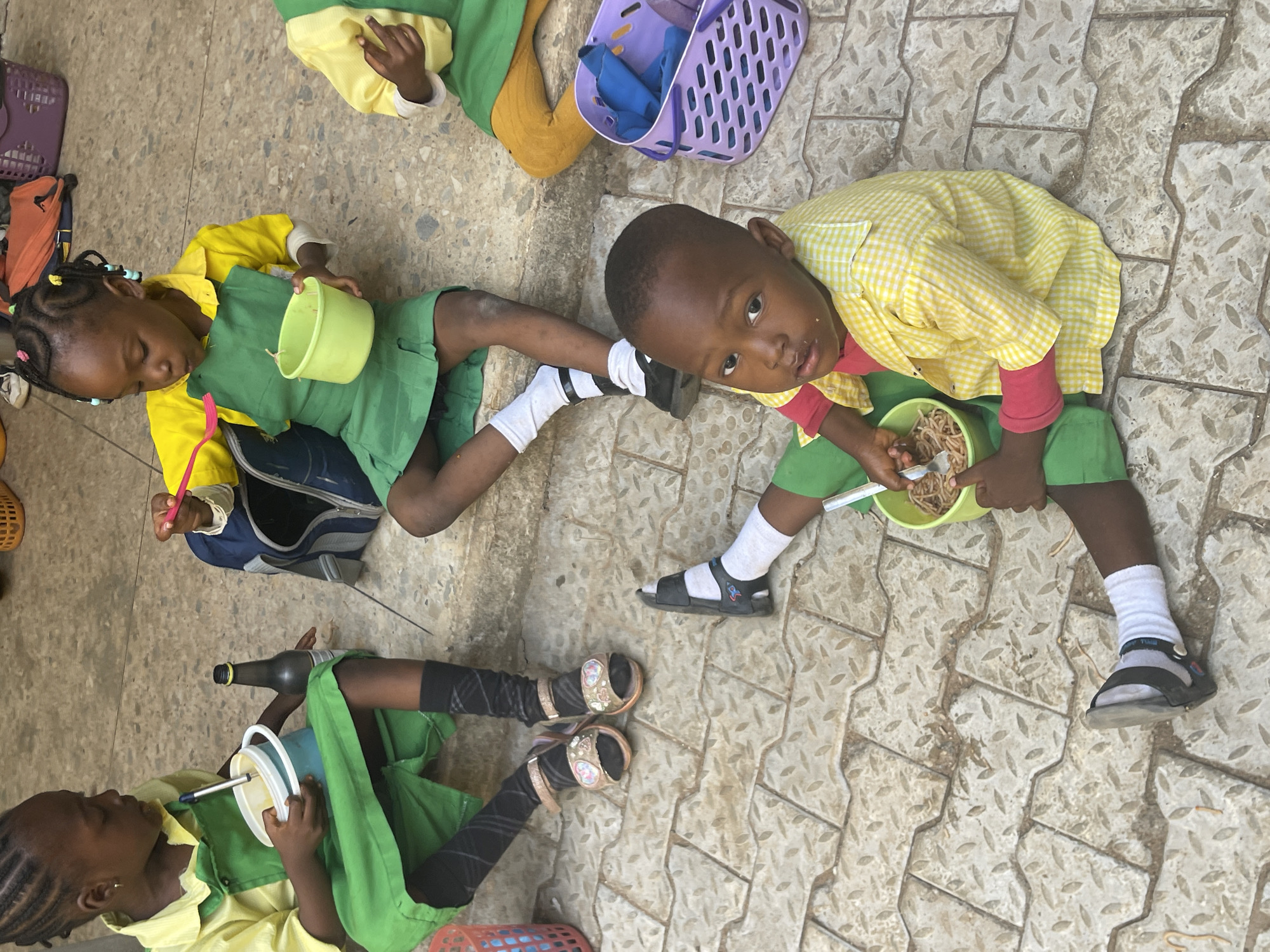 Schoolchildren share outdoor lunch break in Akwanga, Nigeria