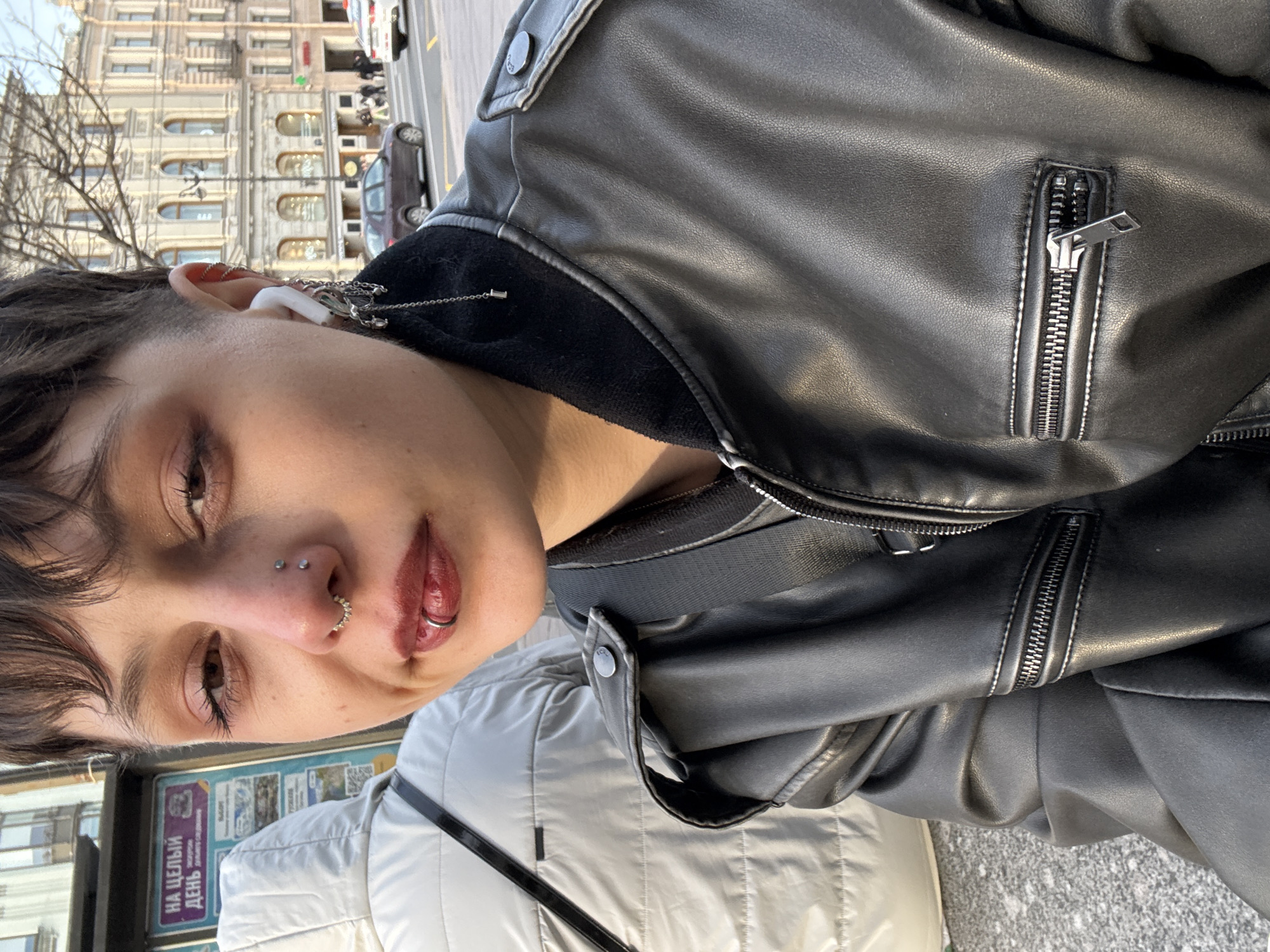 Person with piercings photographs selfie in Saint Petersburg
