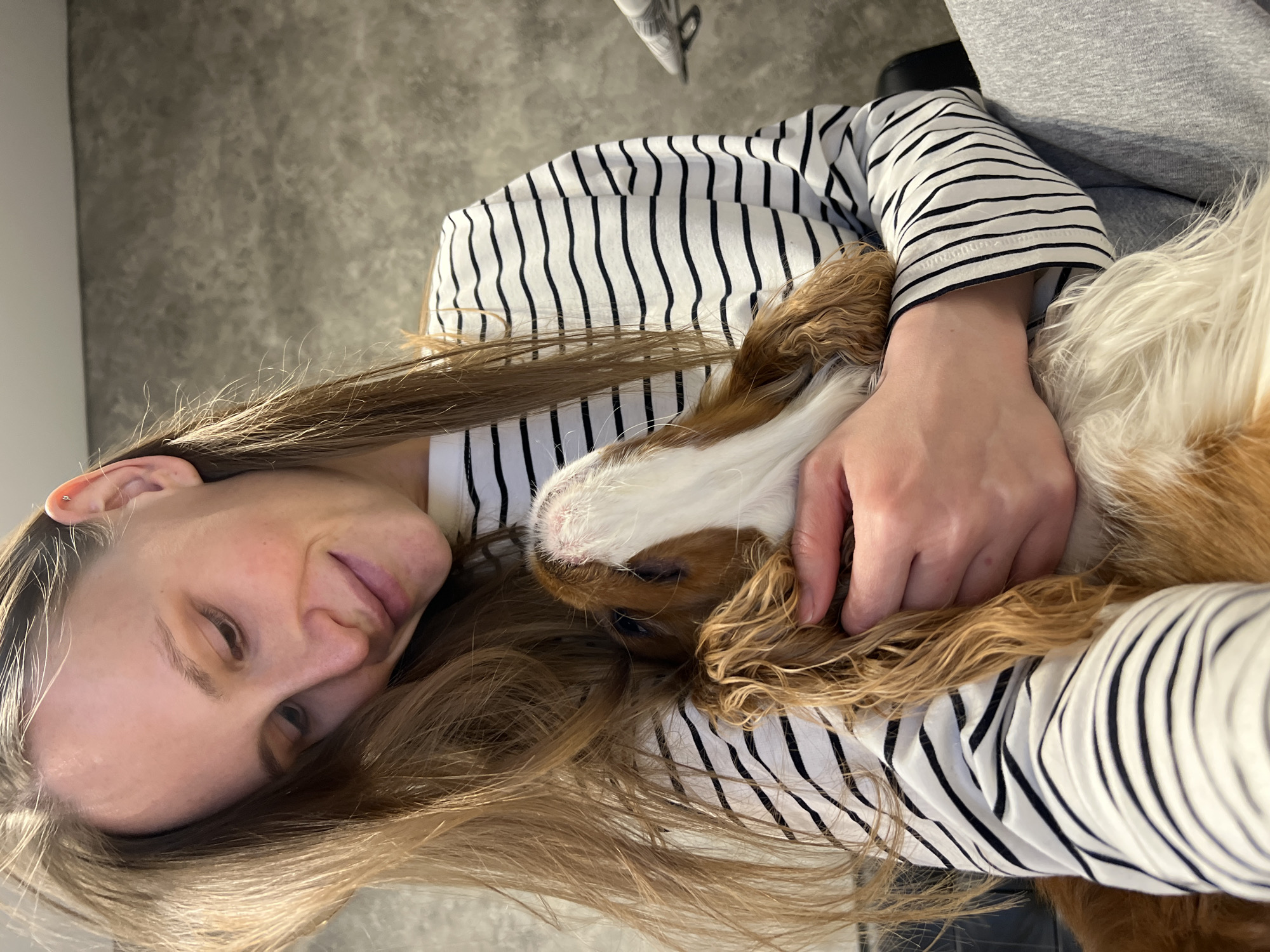 Woman and dog share quiet indoor moment in Khimki