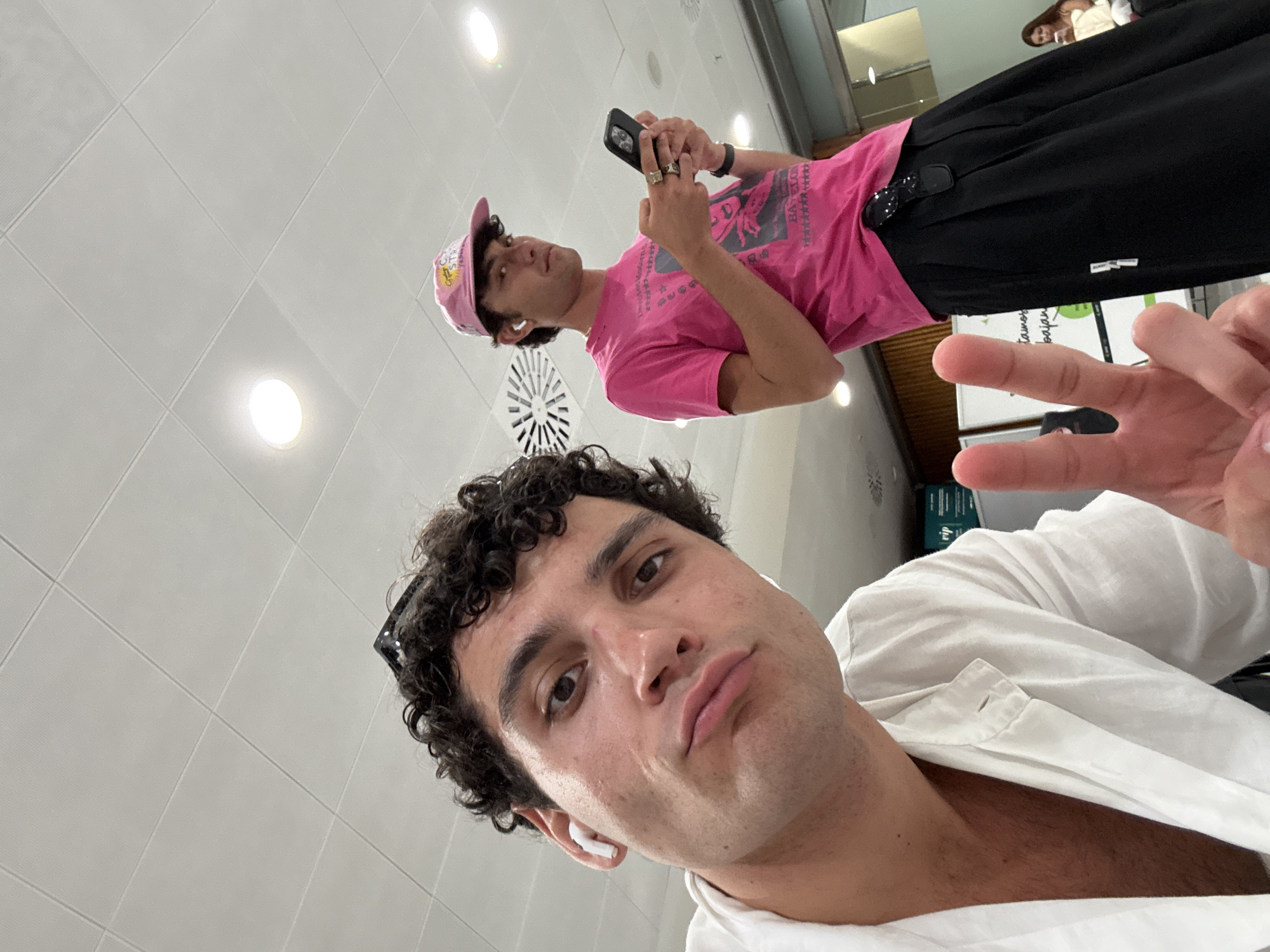 Inside what looks like Ibiza Airport, July evening
