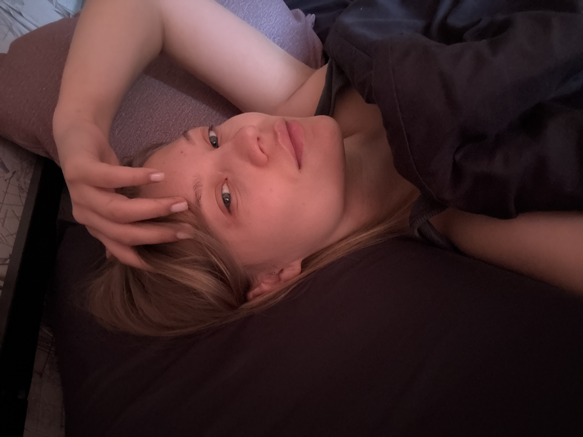 Woman rests in bed early morning in Chaikovsky, Russia