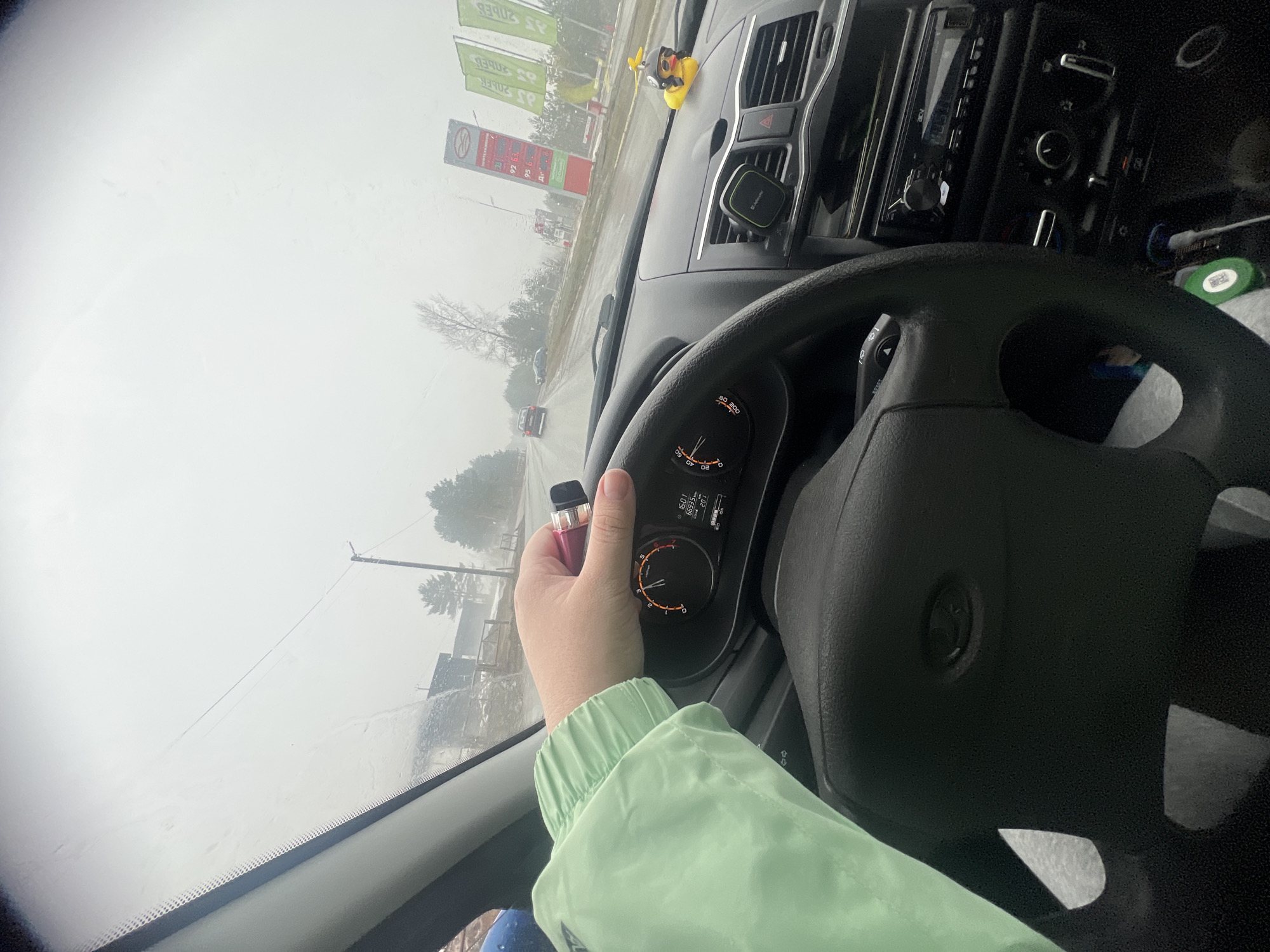 Driver vapes in vehicle during snowy weather in Chaikovsky