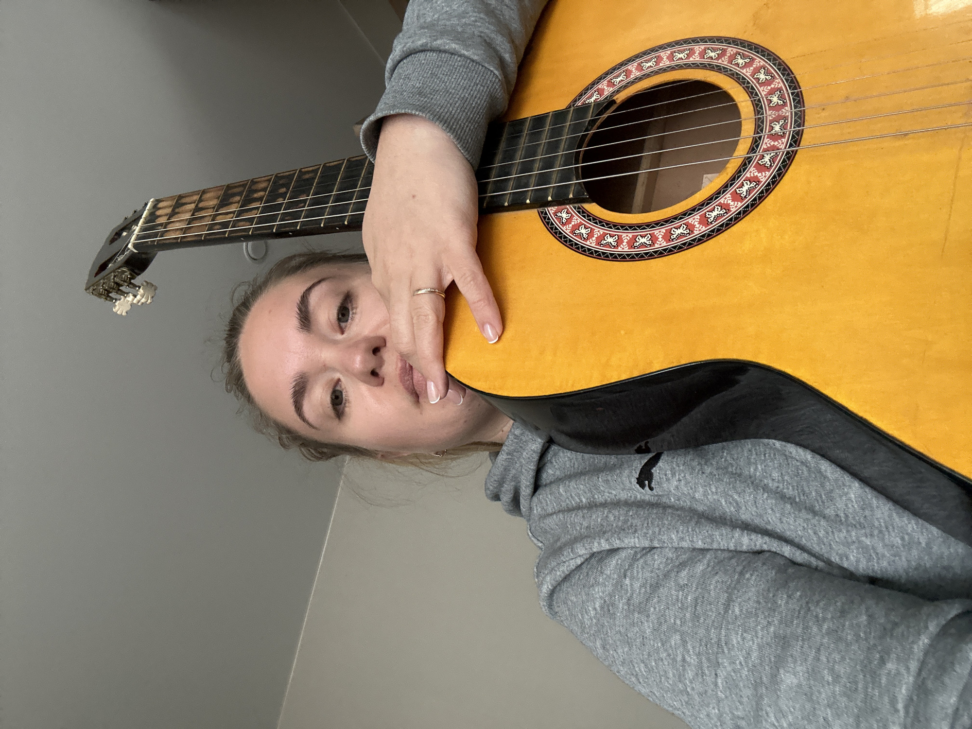 Woman practices guitar at home in rural Russia