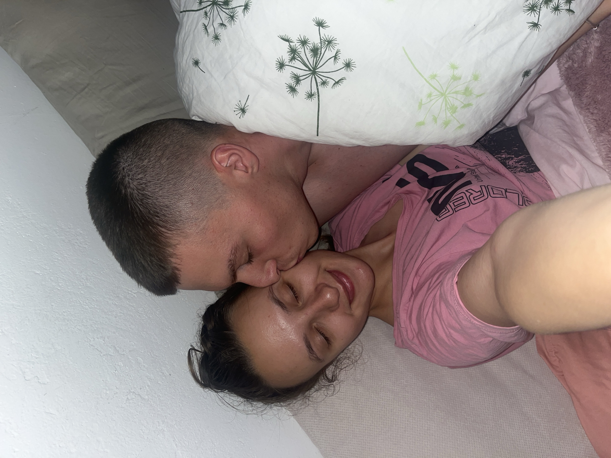 Couple shares tender moment in Saarbrücken bedroom