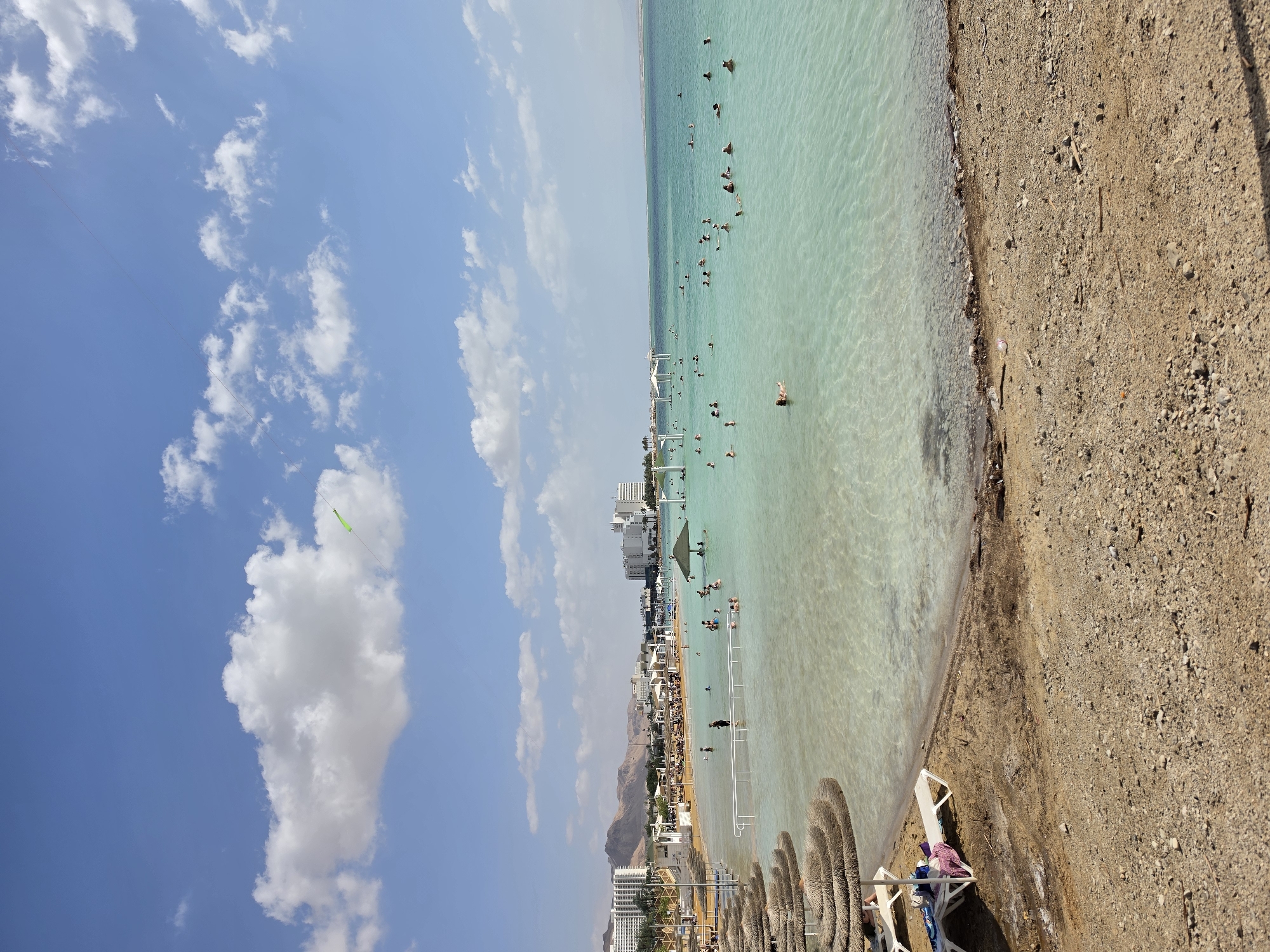 Visitors float in Dead Sea waters near Israeli shore
