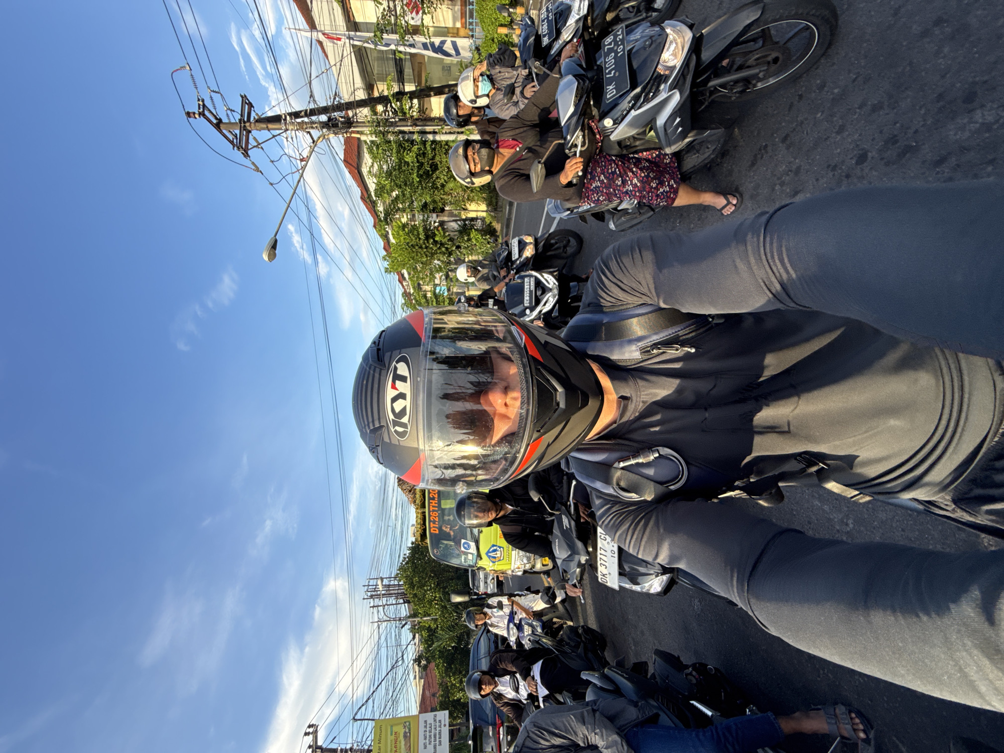 Motorcyclist spotted at Denpasar intersection during evening traffic