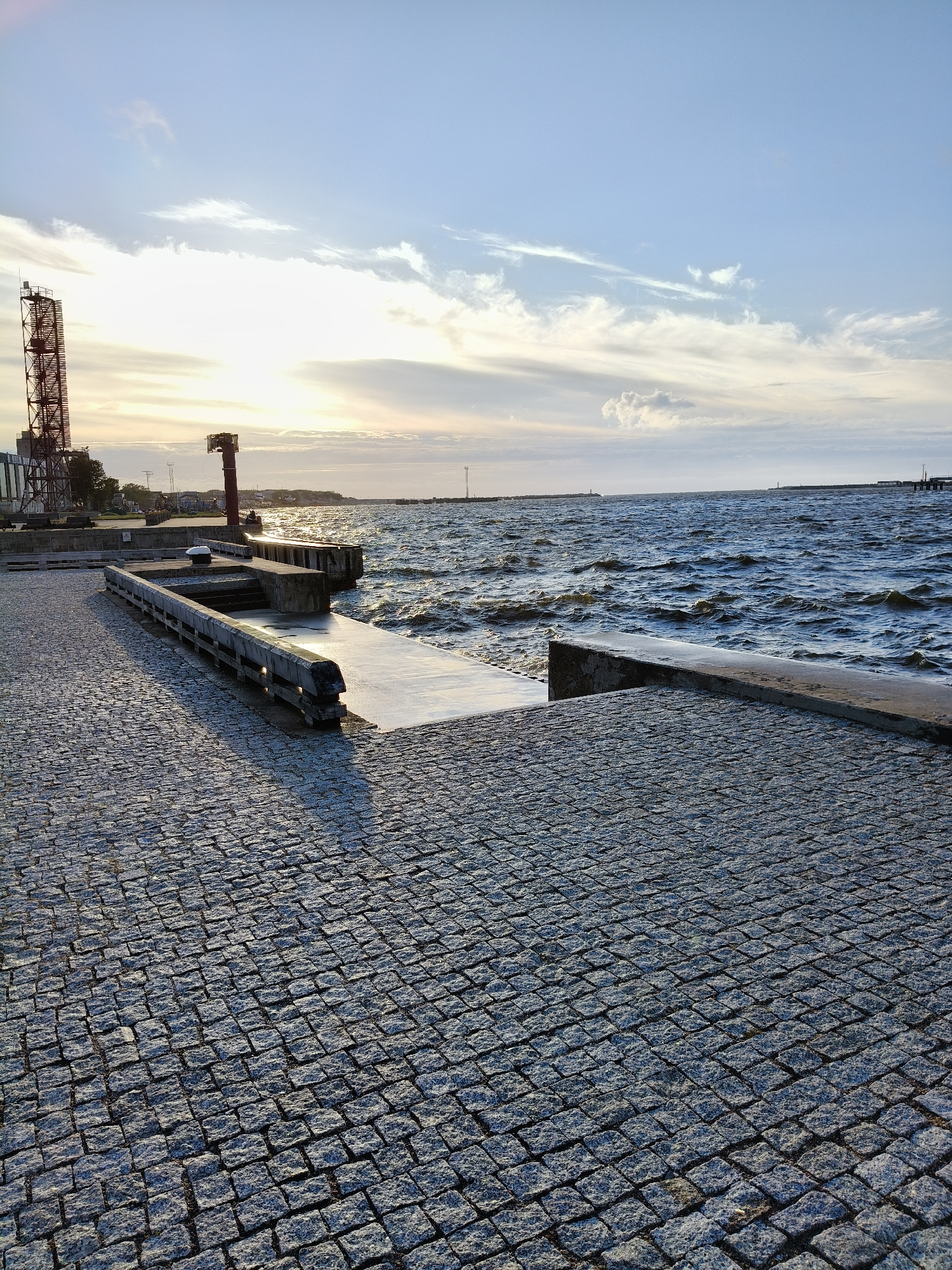 Ventspils waterfront at sunset, Baltic chop and industrial horizon