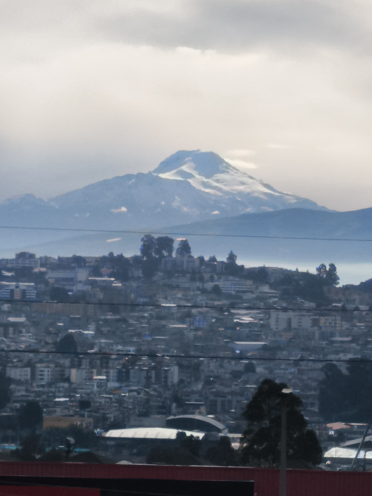 Snow-capped mountain visible over Quito cityscape