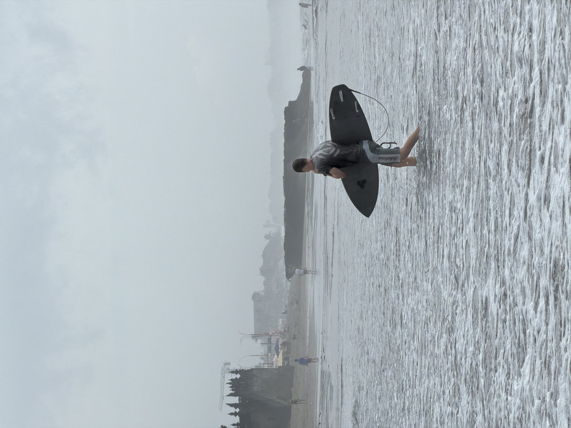 Early morning beach activity captured in North Kuta, Indonesia