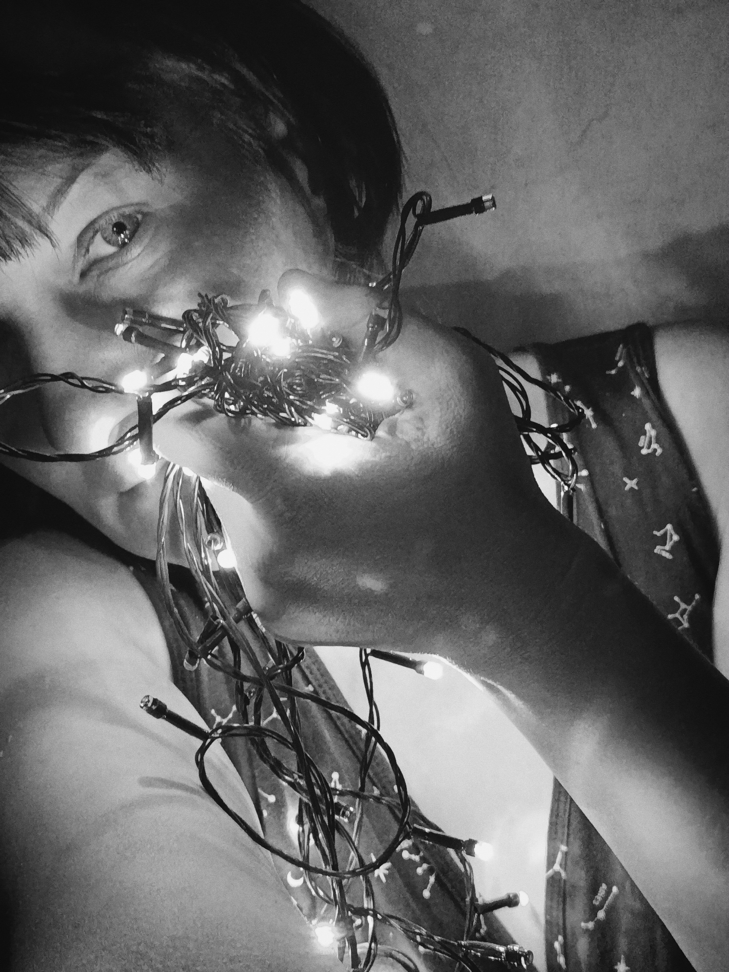 Person untangles Christmas lights indoors in early morning