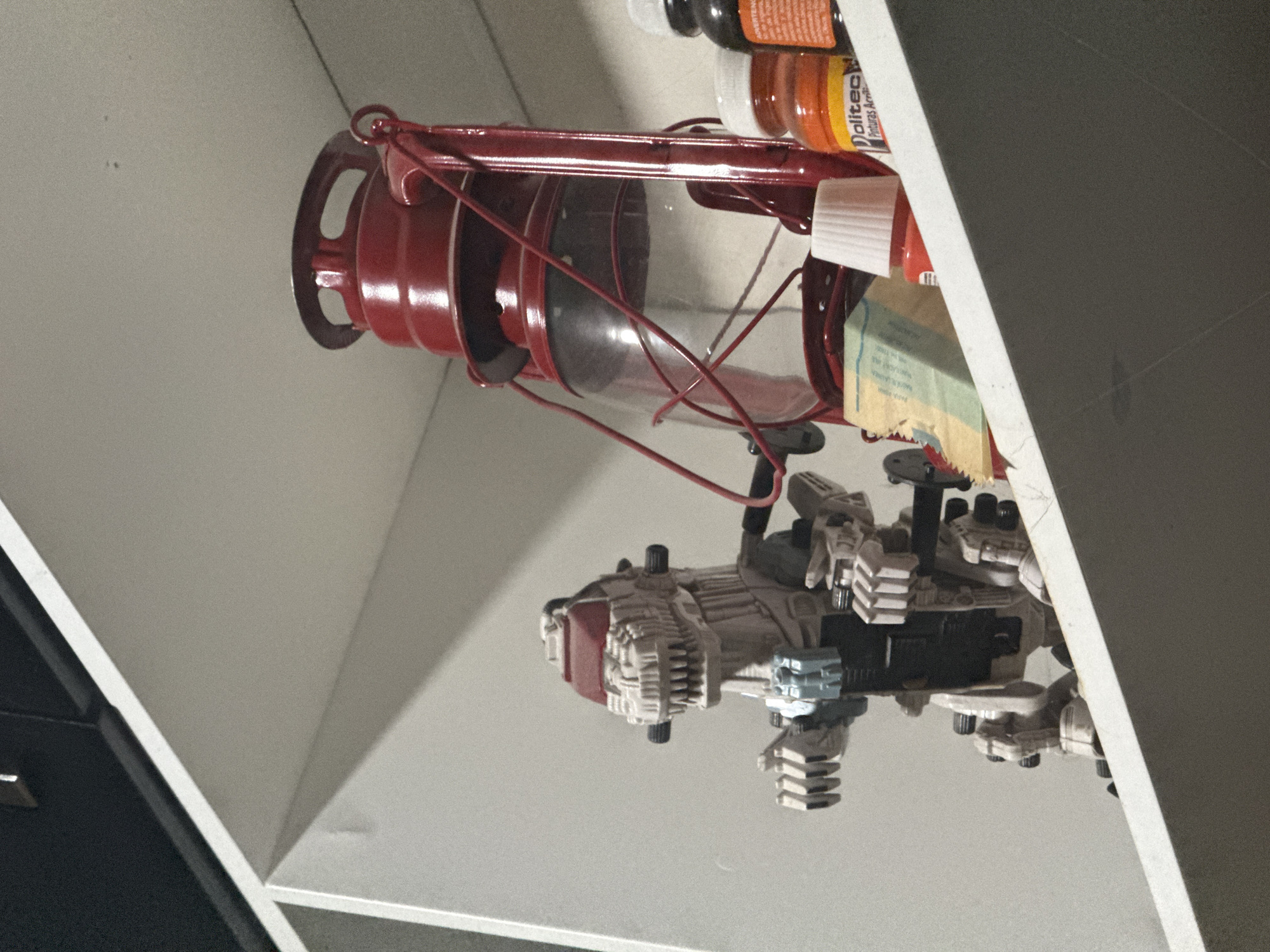 Red vintage lantern photographed in indoor display, Puebla