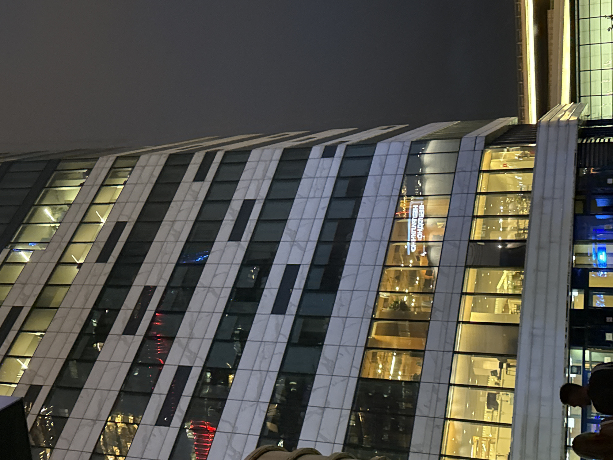Modern building with patterned façade observed in Khimki nightscape