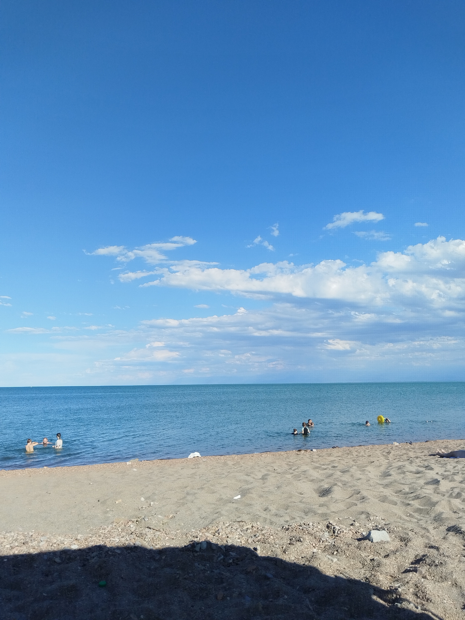 Calm beach day on the Kazakh shoreline near Qonaev