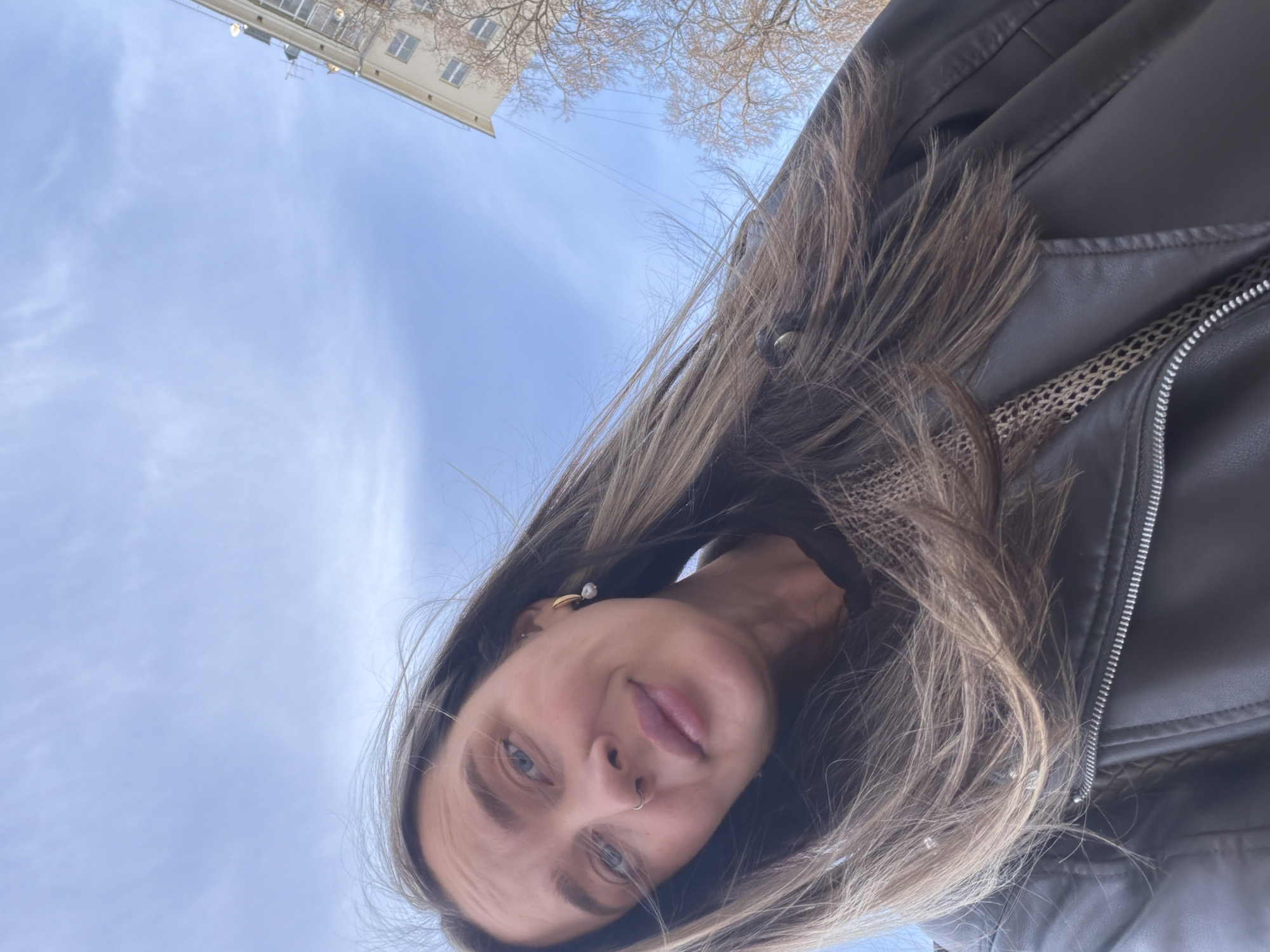 Woman films selfie video in windy Moscow courtyard