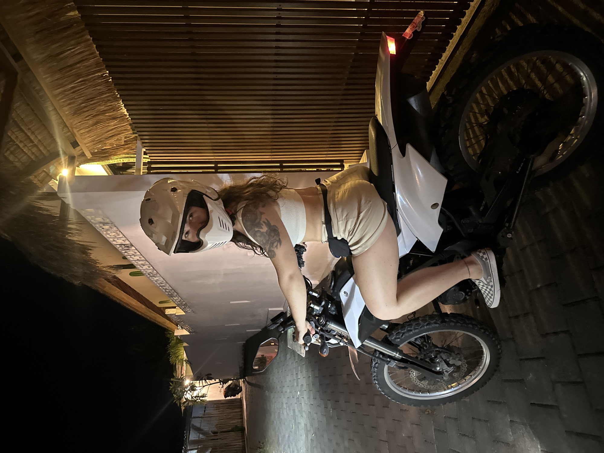 Motorcyclist spotted on dirt bike during nighttime street scene