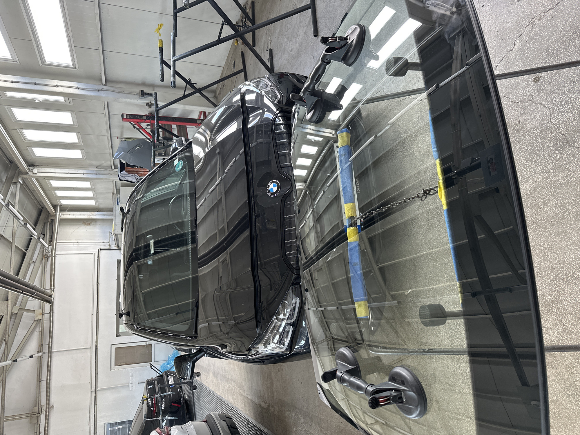 BMW receives windshield service at automotive workshop