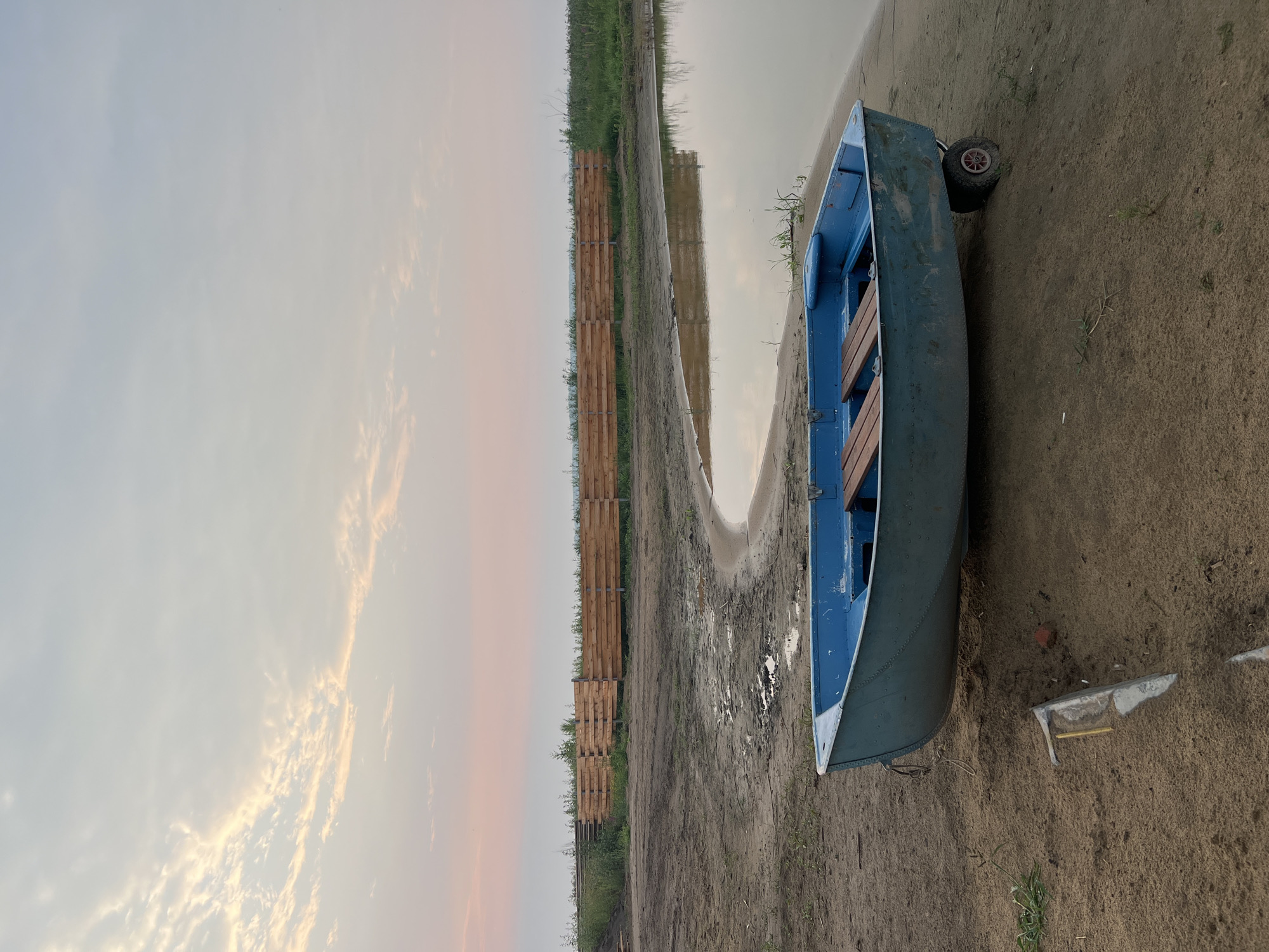Boats at the waterfront as the sun sets over Novopichugovo