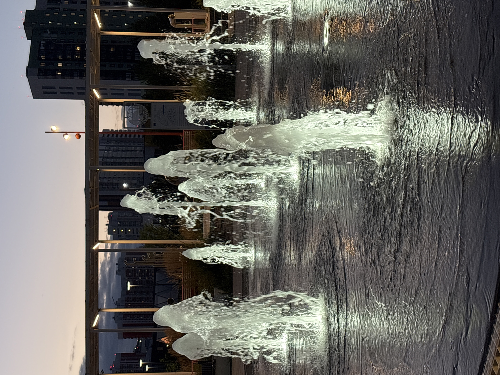 Lit ground fountain cycles through colors on a Kazan evening