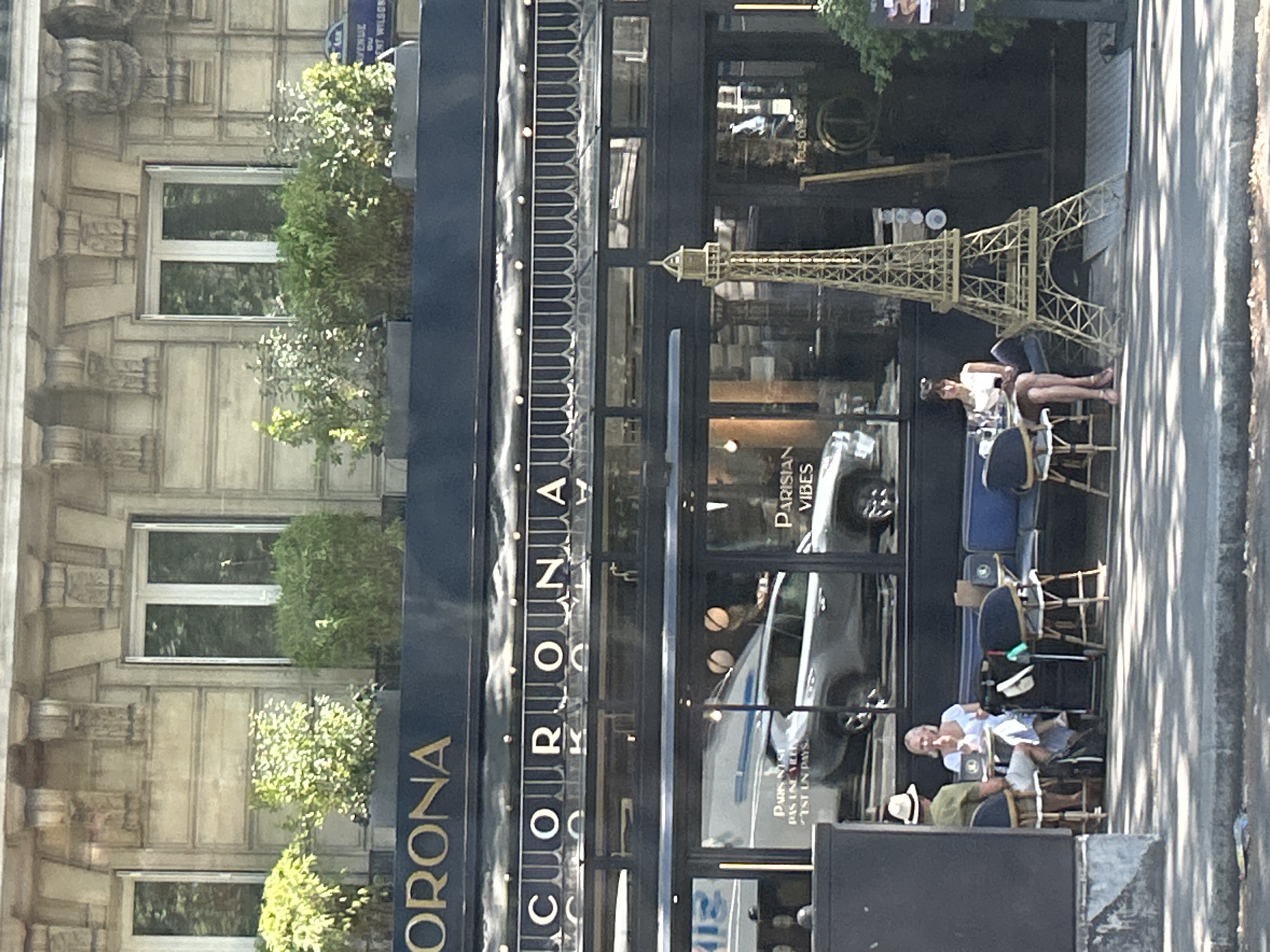 Street-level Paris morning: Eiffel Tower, markets, and café facades
