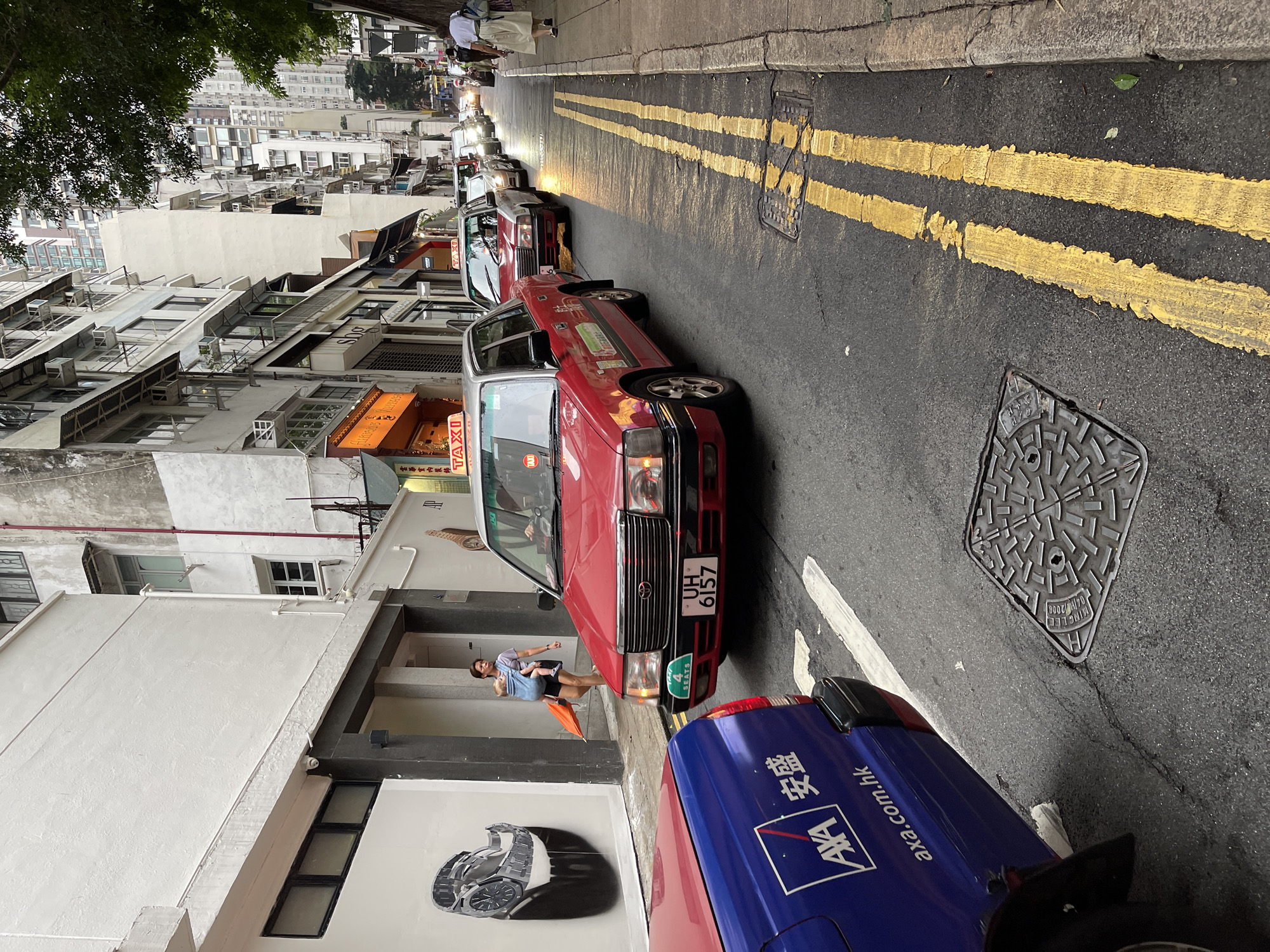 Hong Kong street scenes feature taxis, figurines, Hollywood mural
