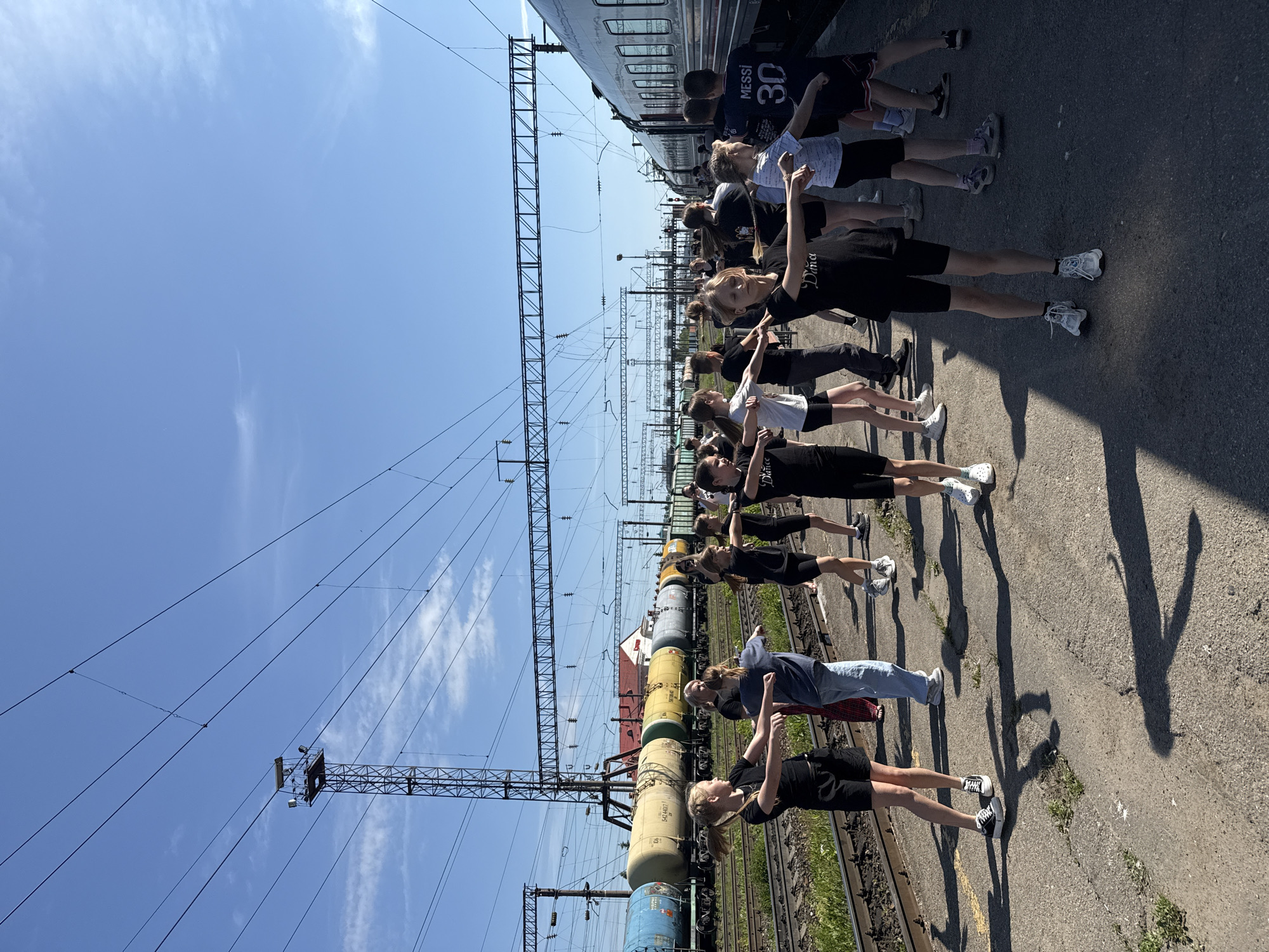 Young group performs synchronized movements on Kanash railway platform