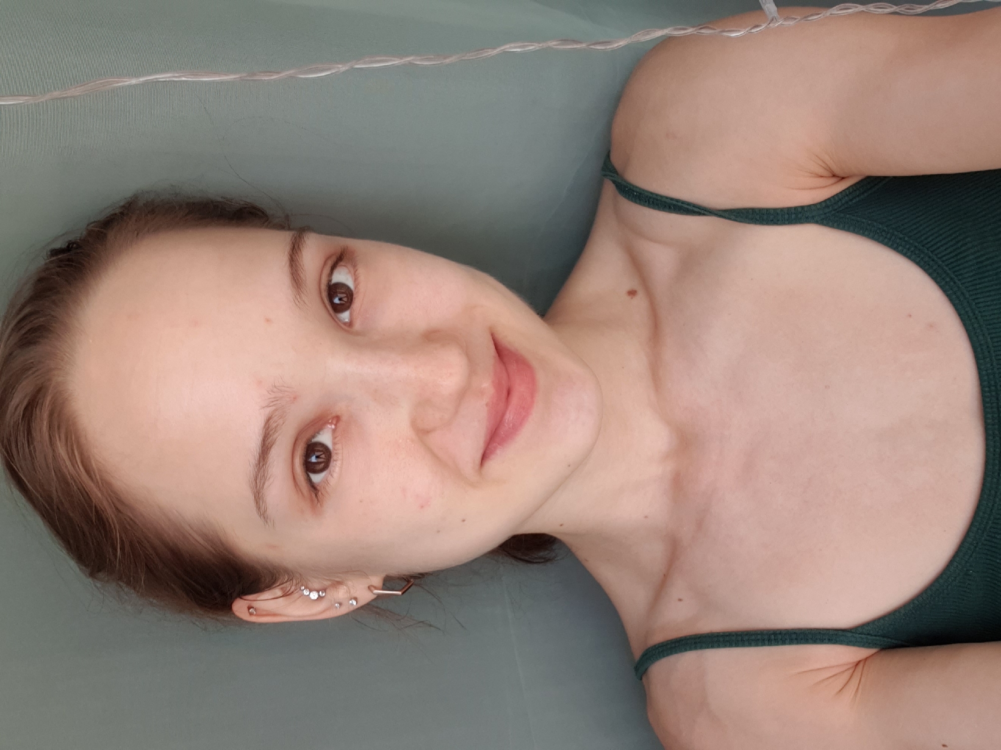 Woman takes selfie in dark green tank top in Khimki