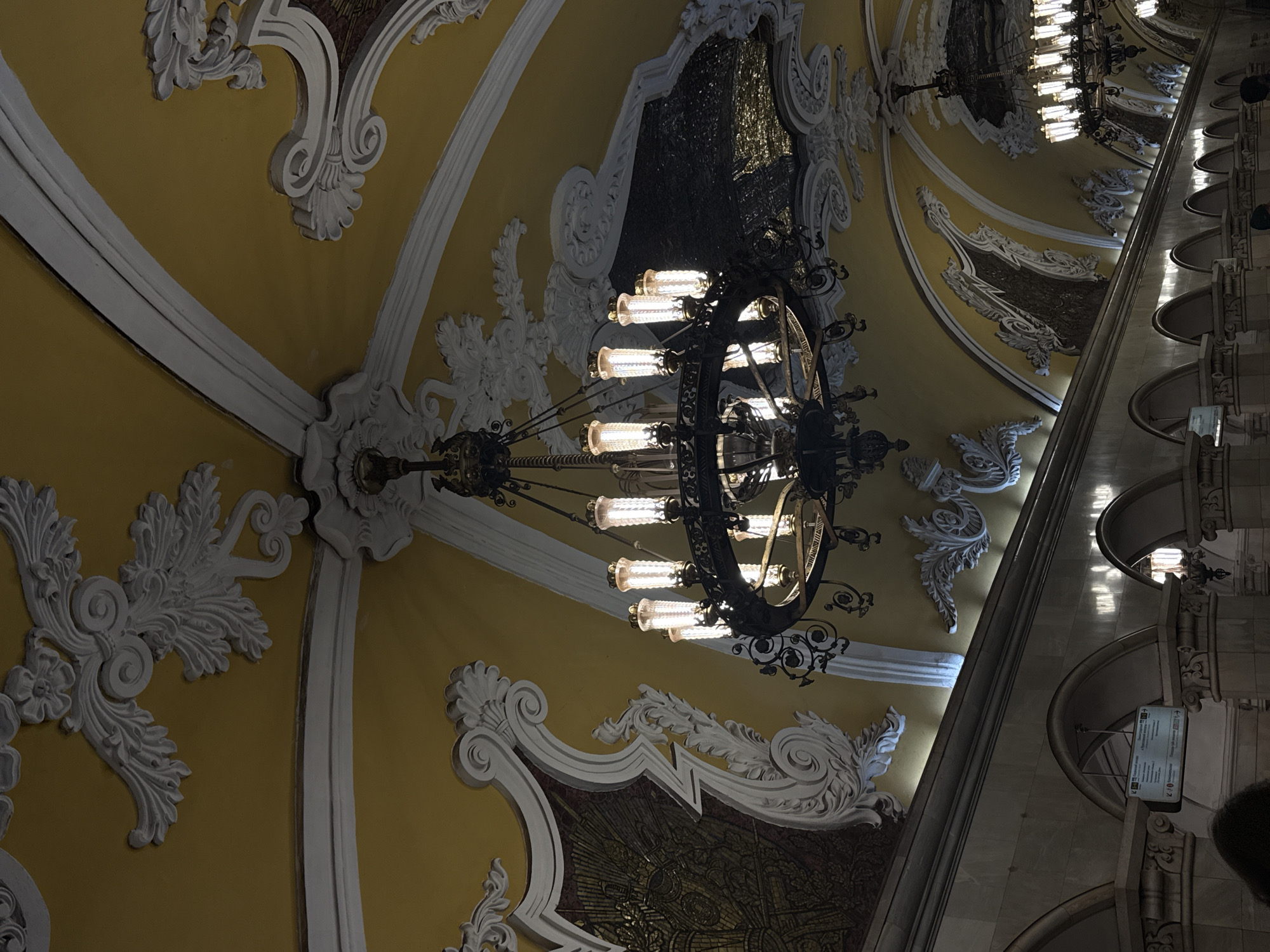 Tourist takes selfie at ornate Moscow metro station