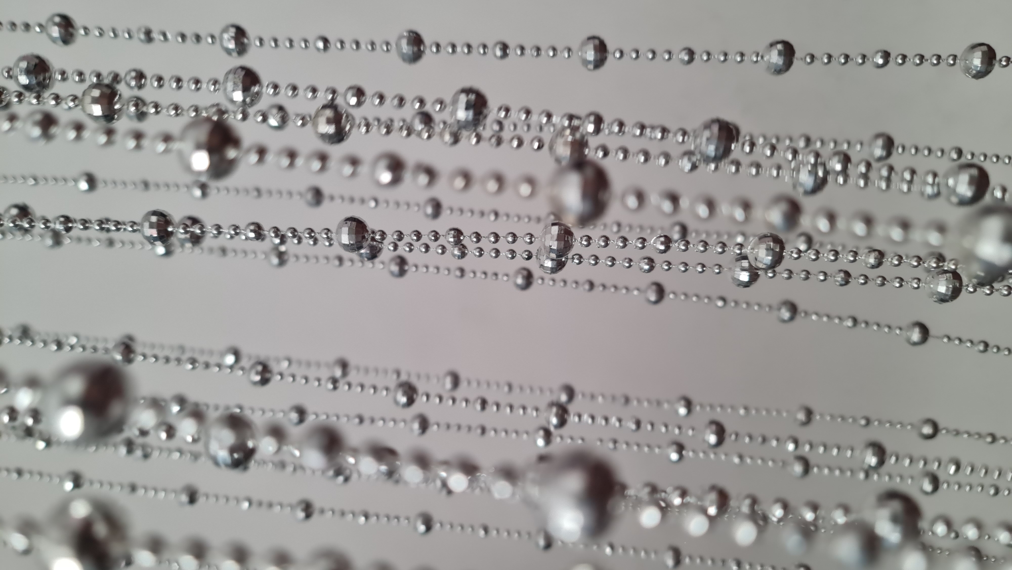 Close-up study of silver beaded strands in Klaipėda