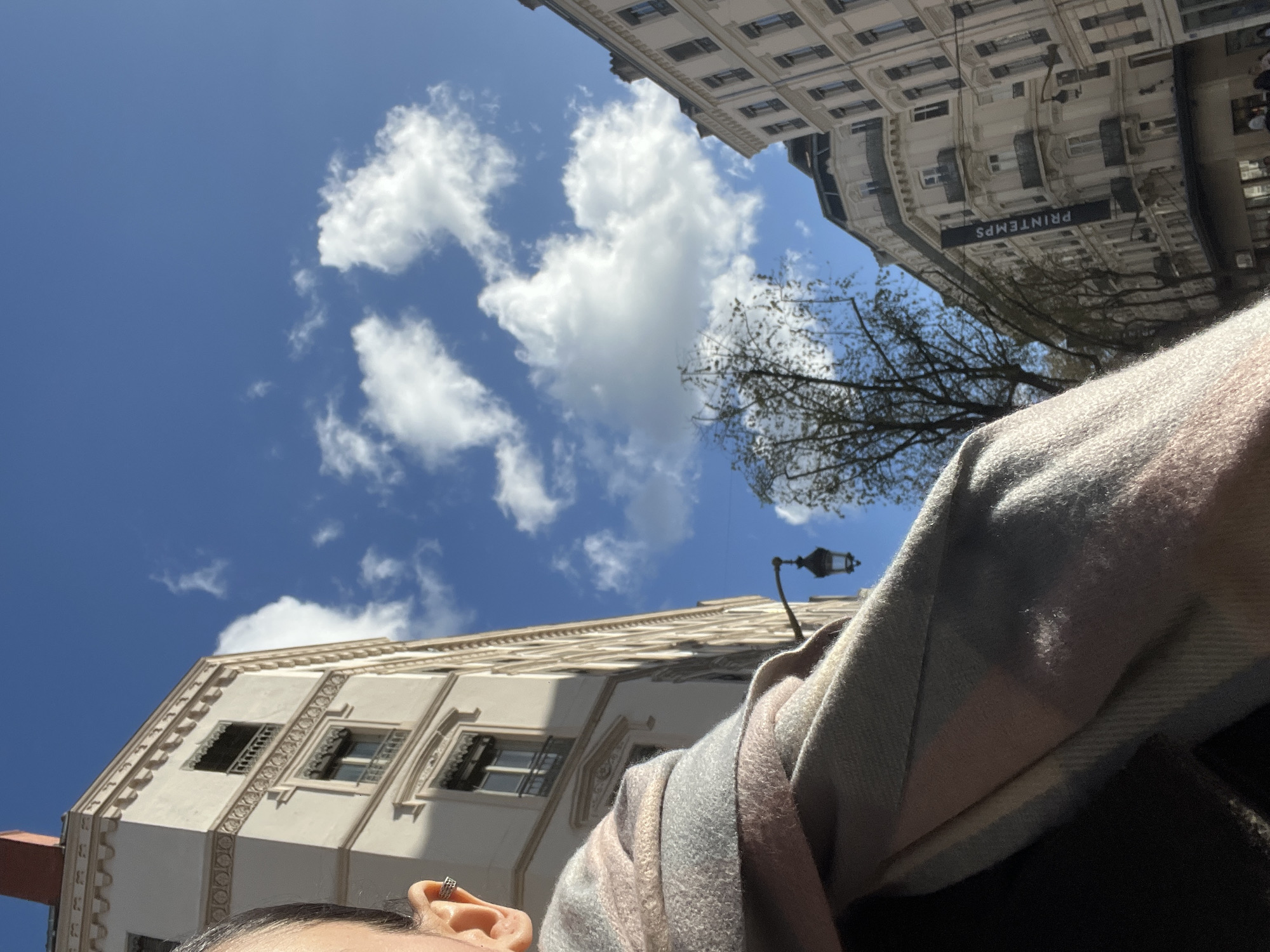 Low-angle street photography captures person against Lyon cityscape
