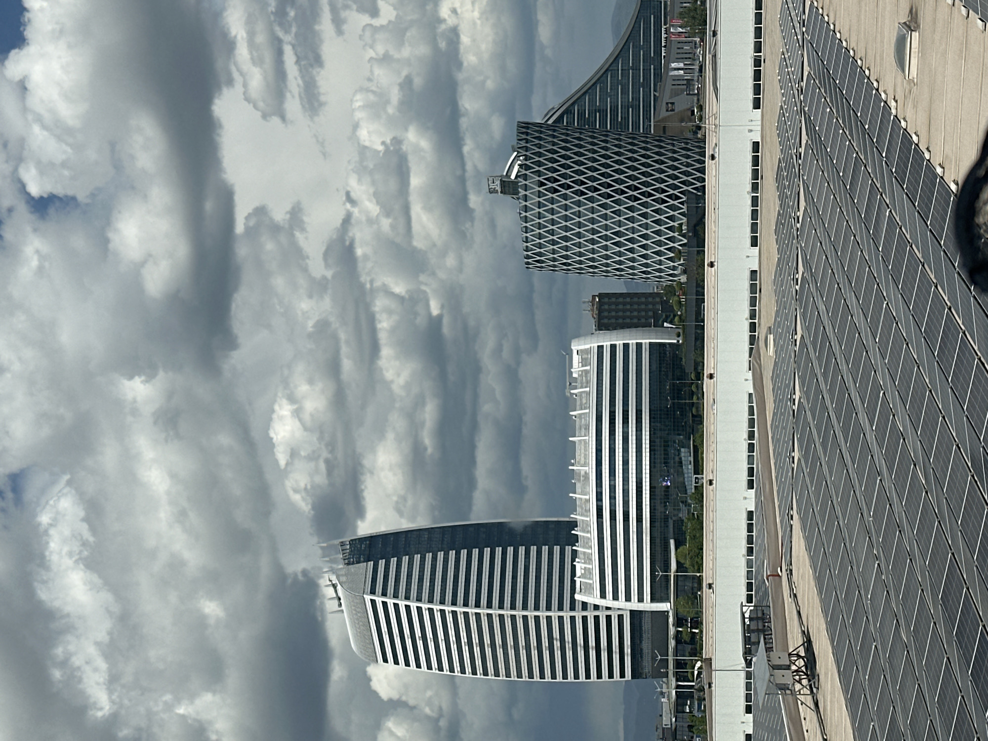 Solar-paneled building observed in Sofia cityscape under cloudy skies