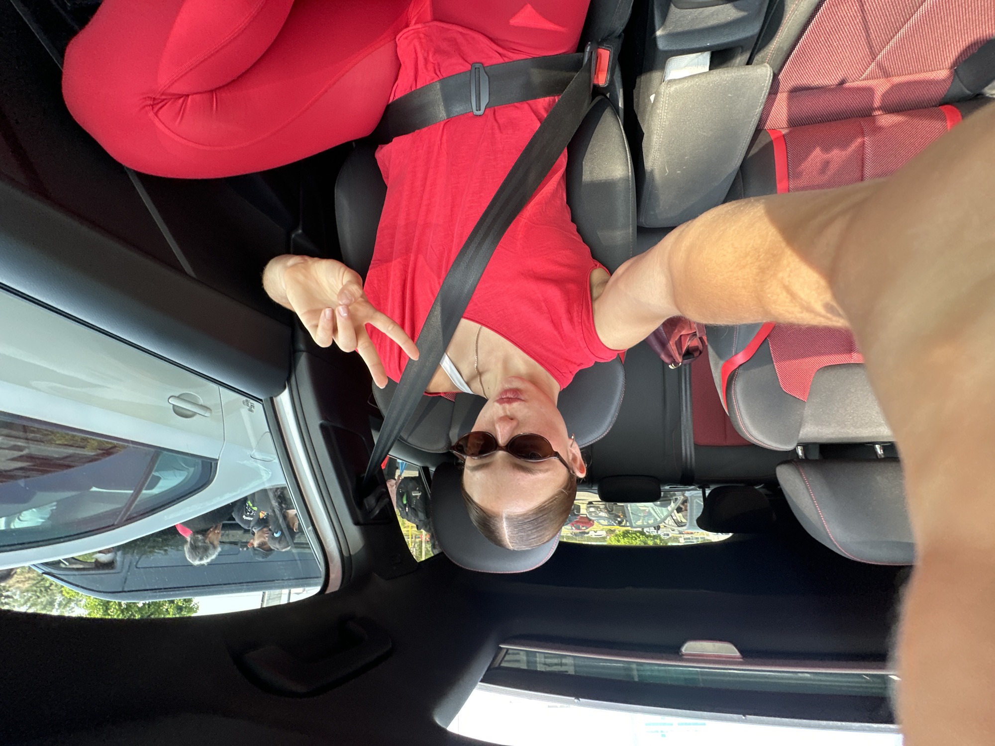 Woman makes peace sign while seated in car in Mexico